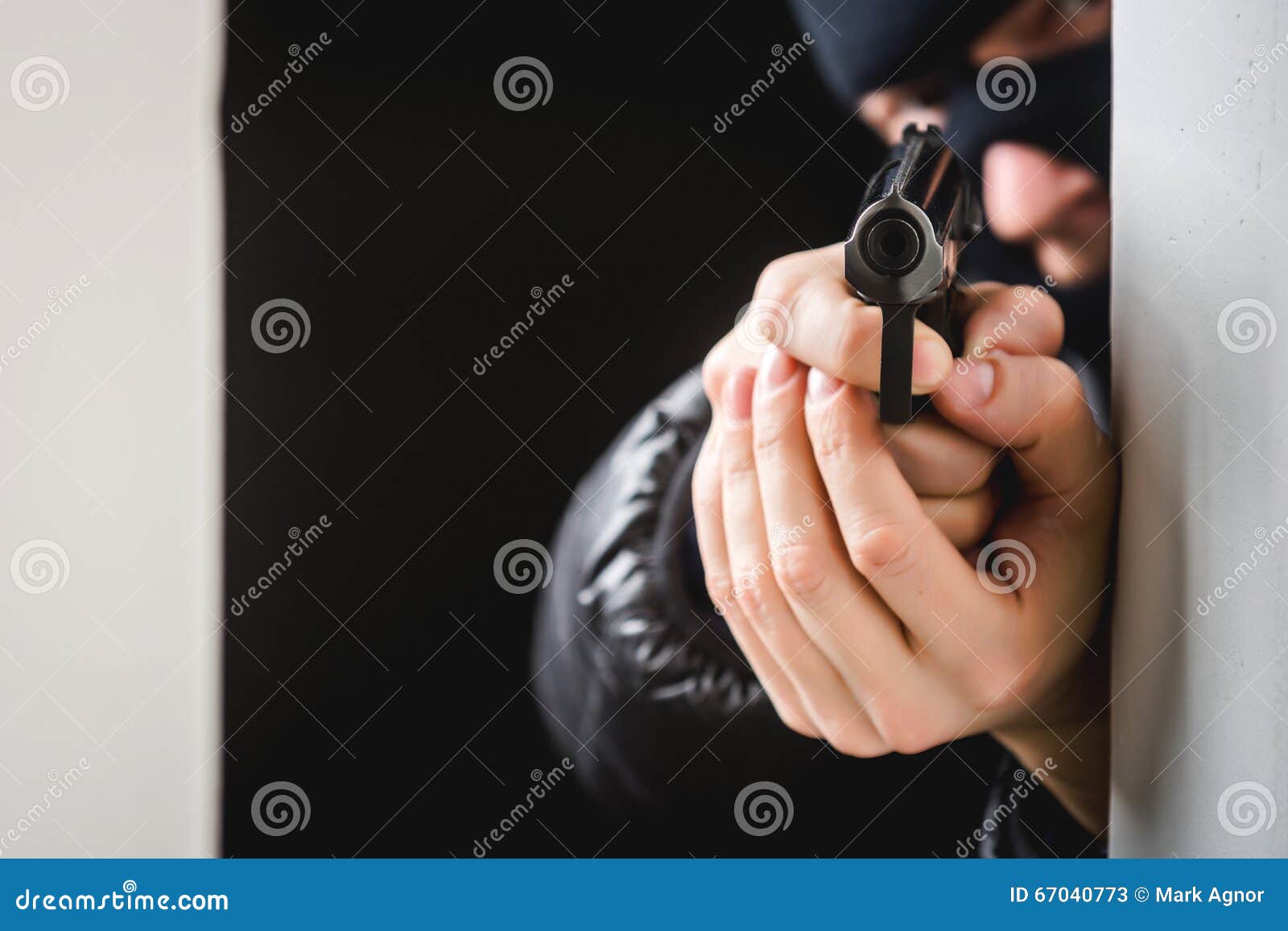 Robbery in store. Robber is aiming and threatening with gun in shop. Stock  Photo