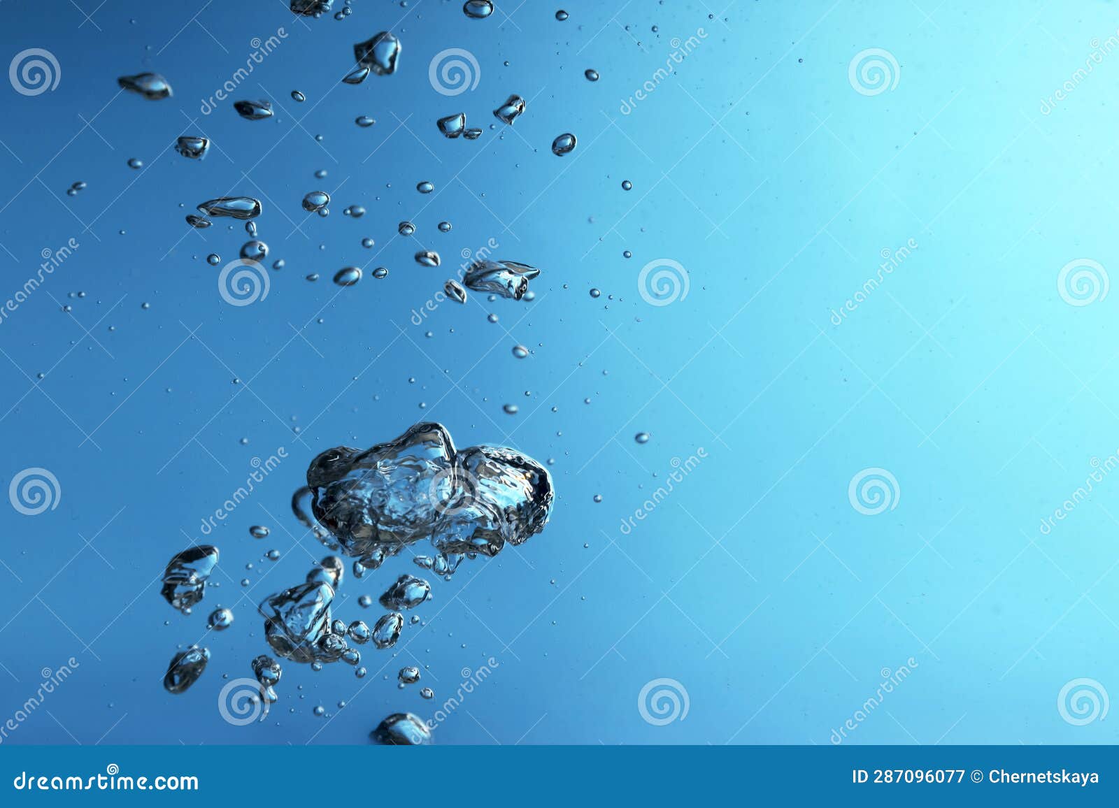 Air Bubbles in Water on Blue Background. Space for Text Stock Image