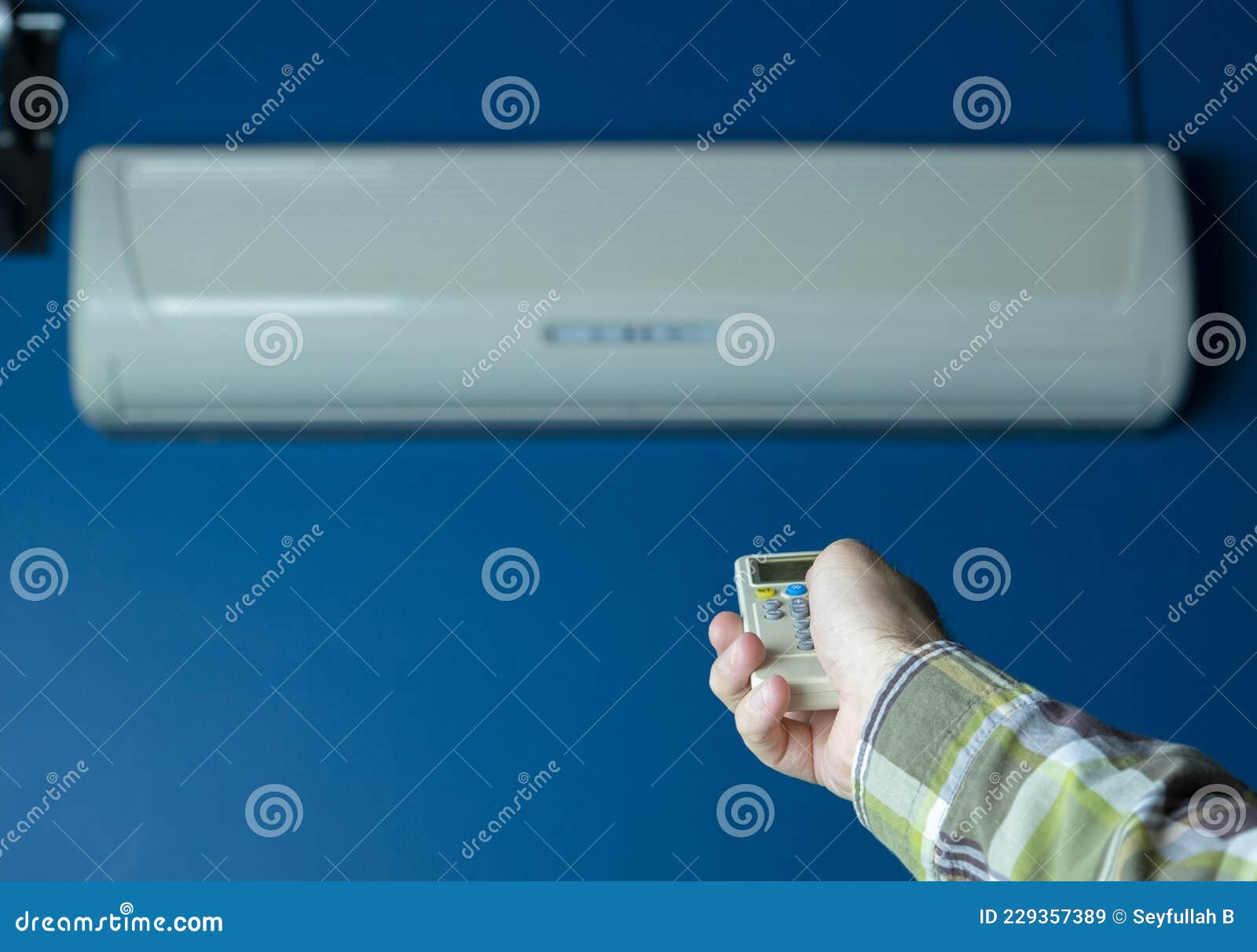 Air Conditioner Control with Remote Control. Air Conditioner on Blue