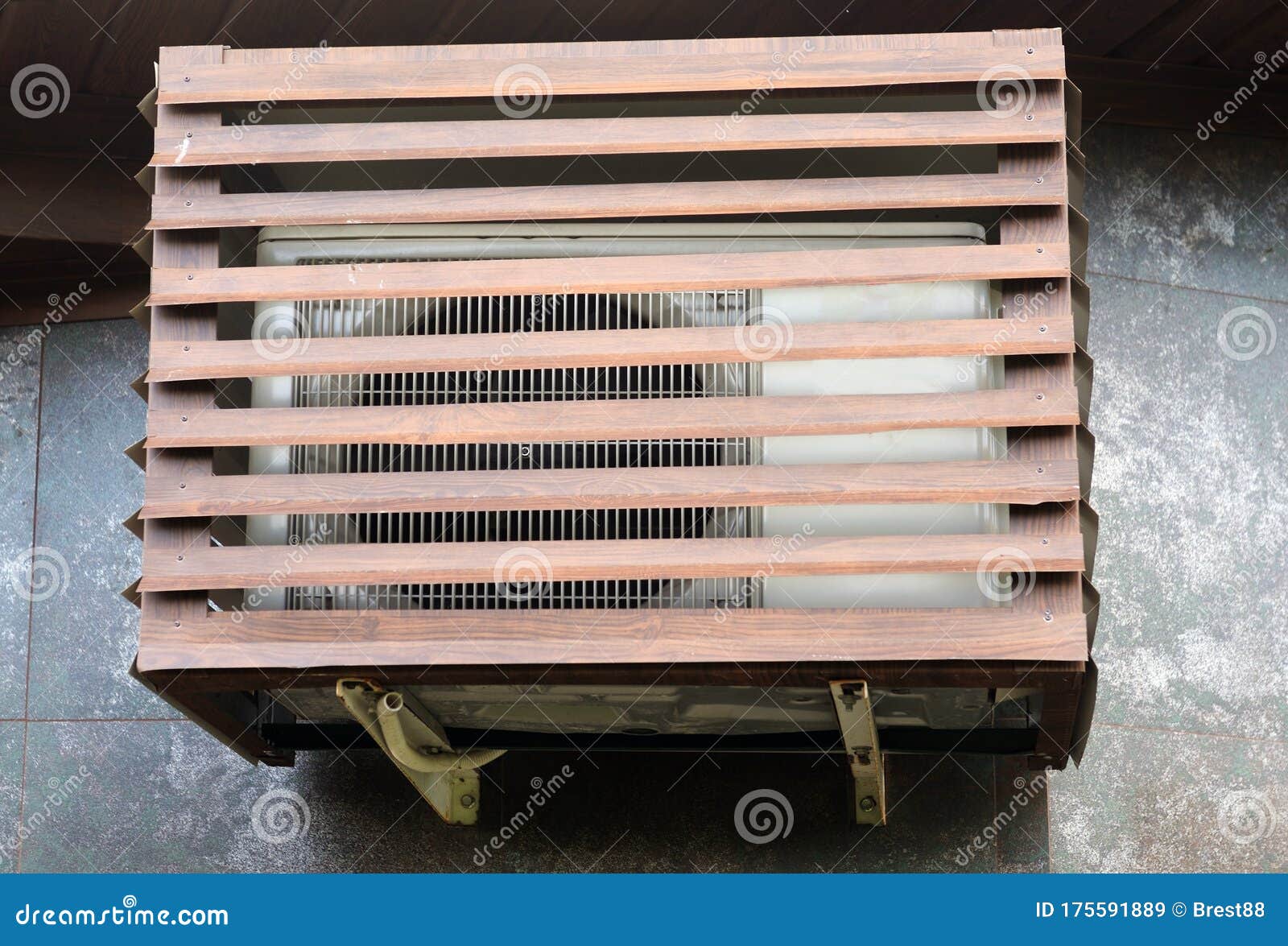 The Air Conditioner Installed on the Street is Protected by a Metal