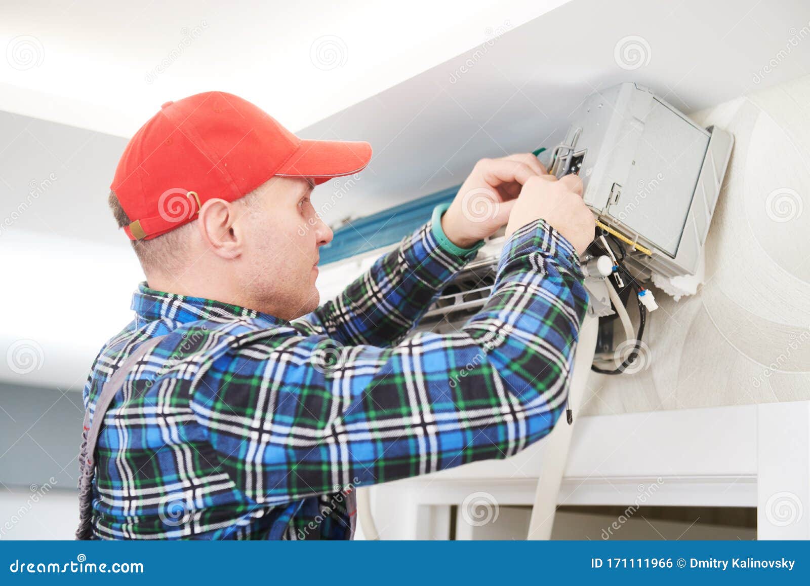 Air Conditioner Service. Worker at Climatization System Installation
