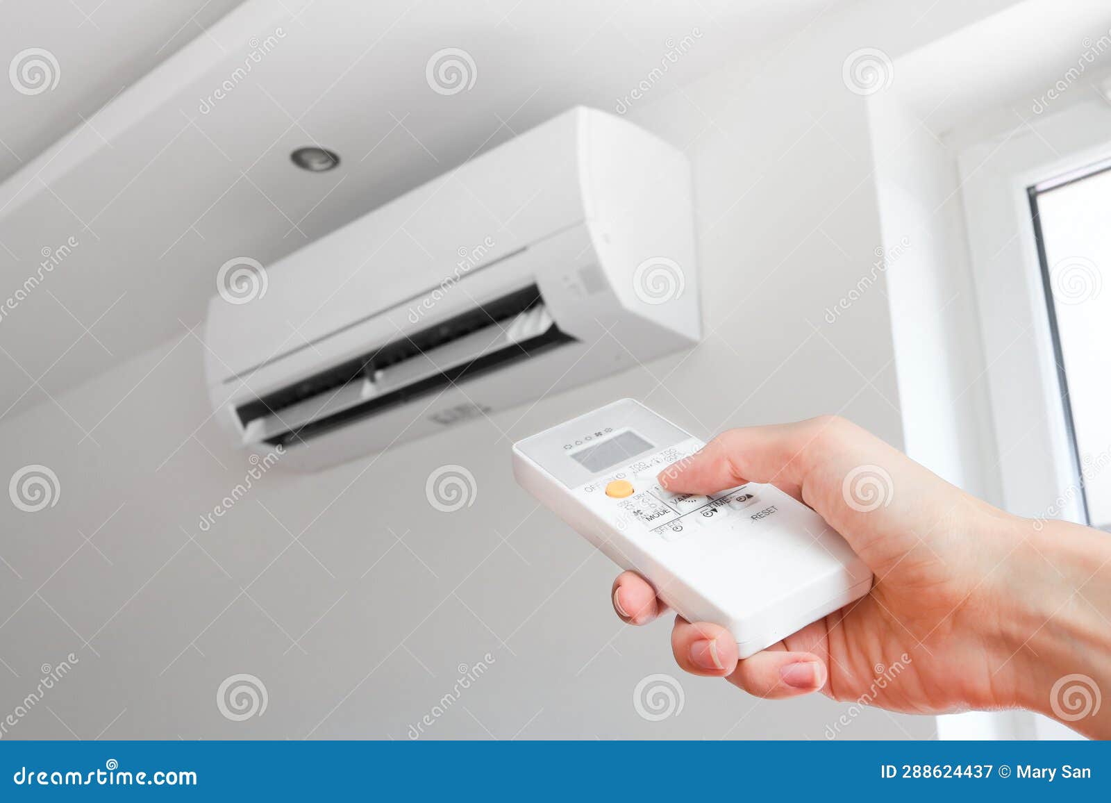 Air Conditioner Temperature Adjustment with Remote Controller in Room