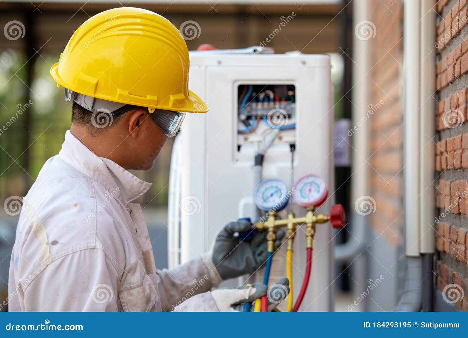Air Conditioning Technician is Checking the Compressor with Gauge Stock