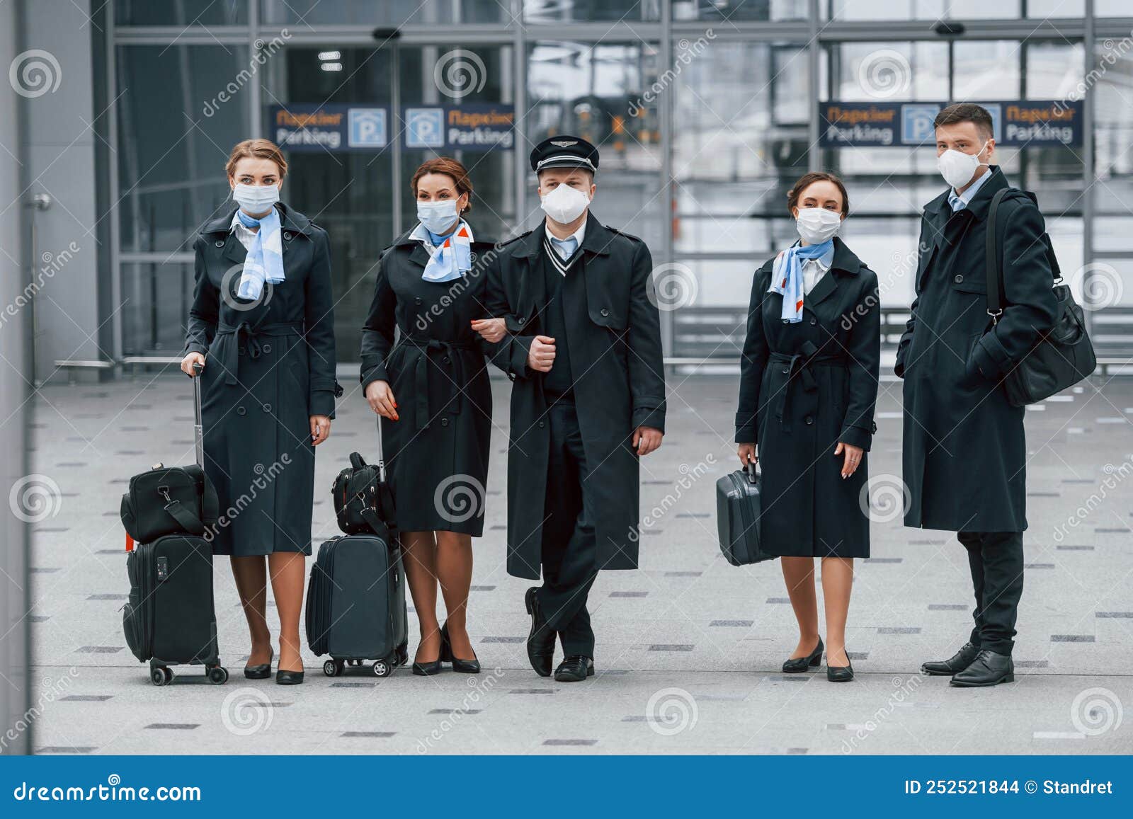 Aircraft Crew in Work Uniform is Together Outdoors in the Airport Stock