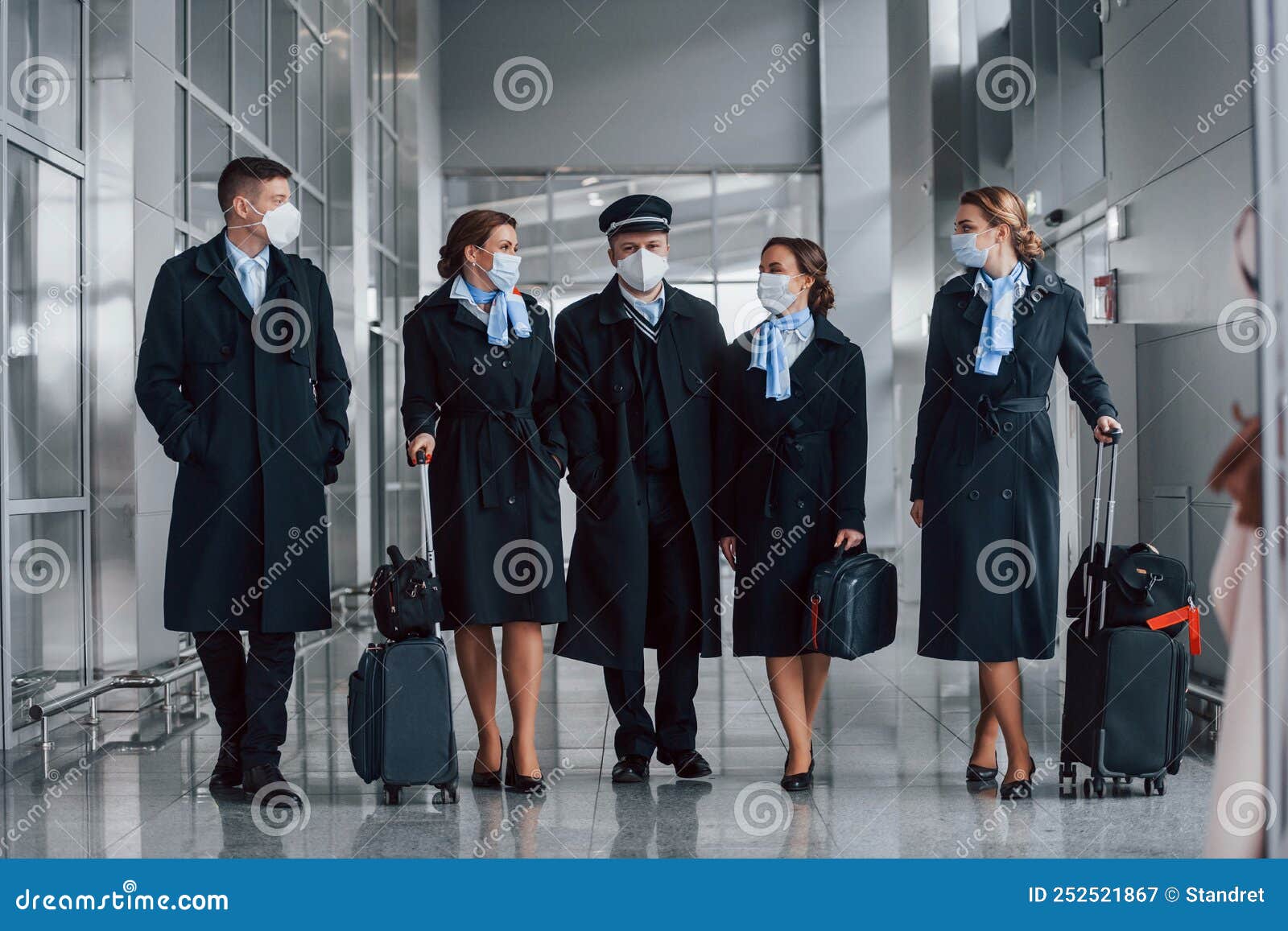 Aircraft Crew in Work Uniform is Together Outdoors in the Airport Stock