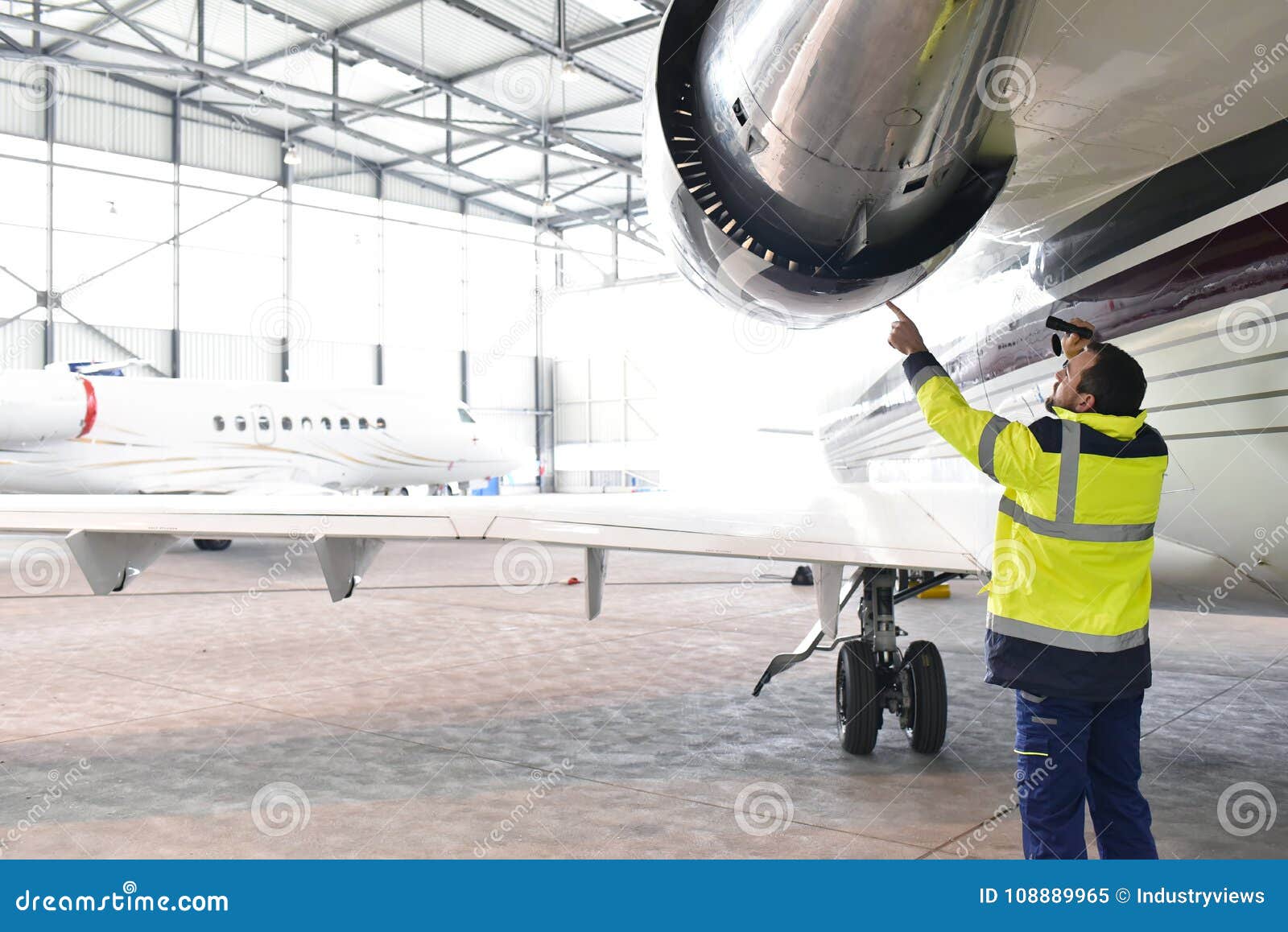 aircraft mechanic/ ground crew inspects and checks the turbine
