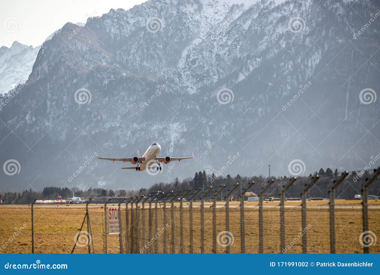 airplane scenery:  take off from airport, mountain range in the alps. travel by air, transportation