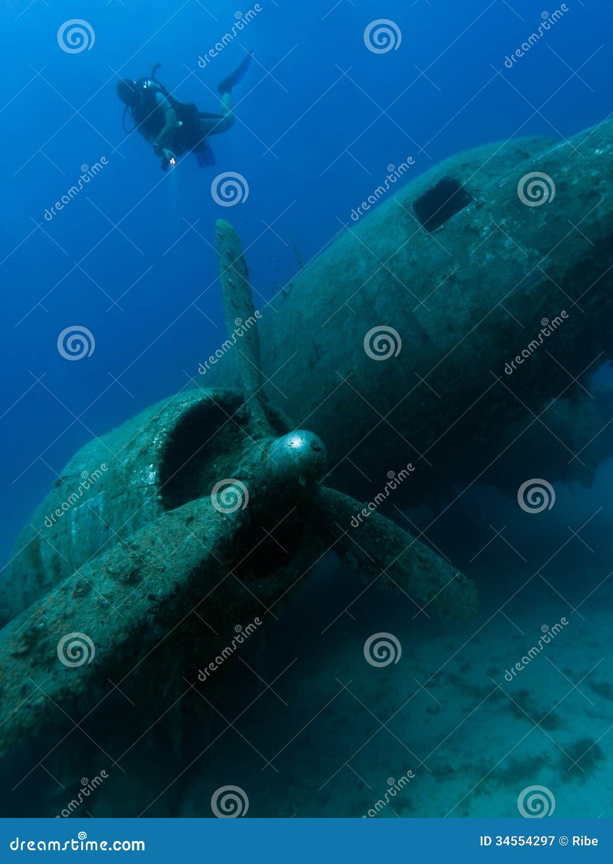 diver exploring wreck of aircraft