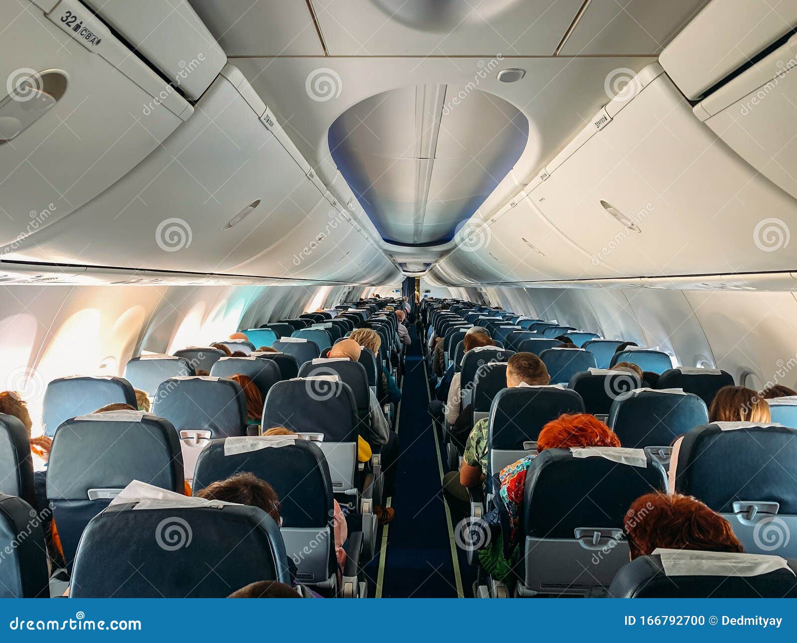 Airplane Interior Inside with Passengers in Flight Stock Photo Image