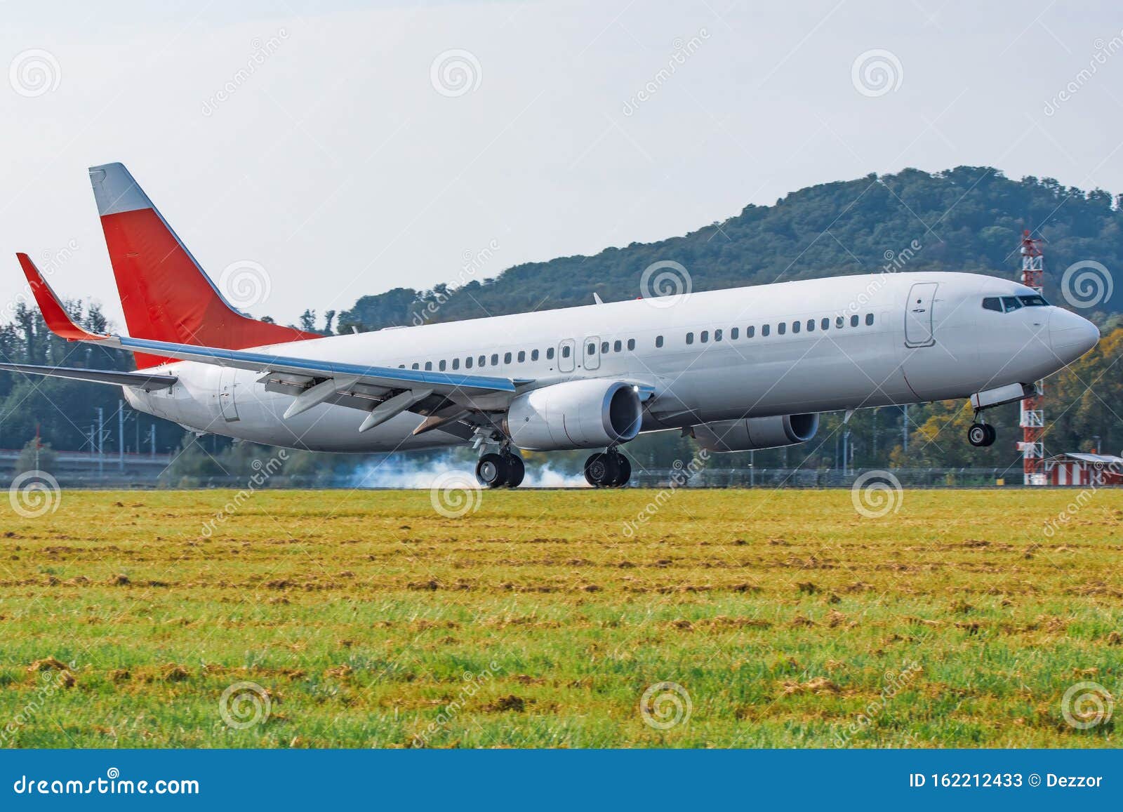 Airplane Landing on Runway Side View Touchdown with Tire Smoke Stock