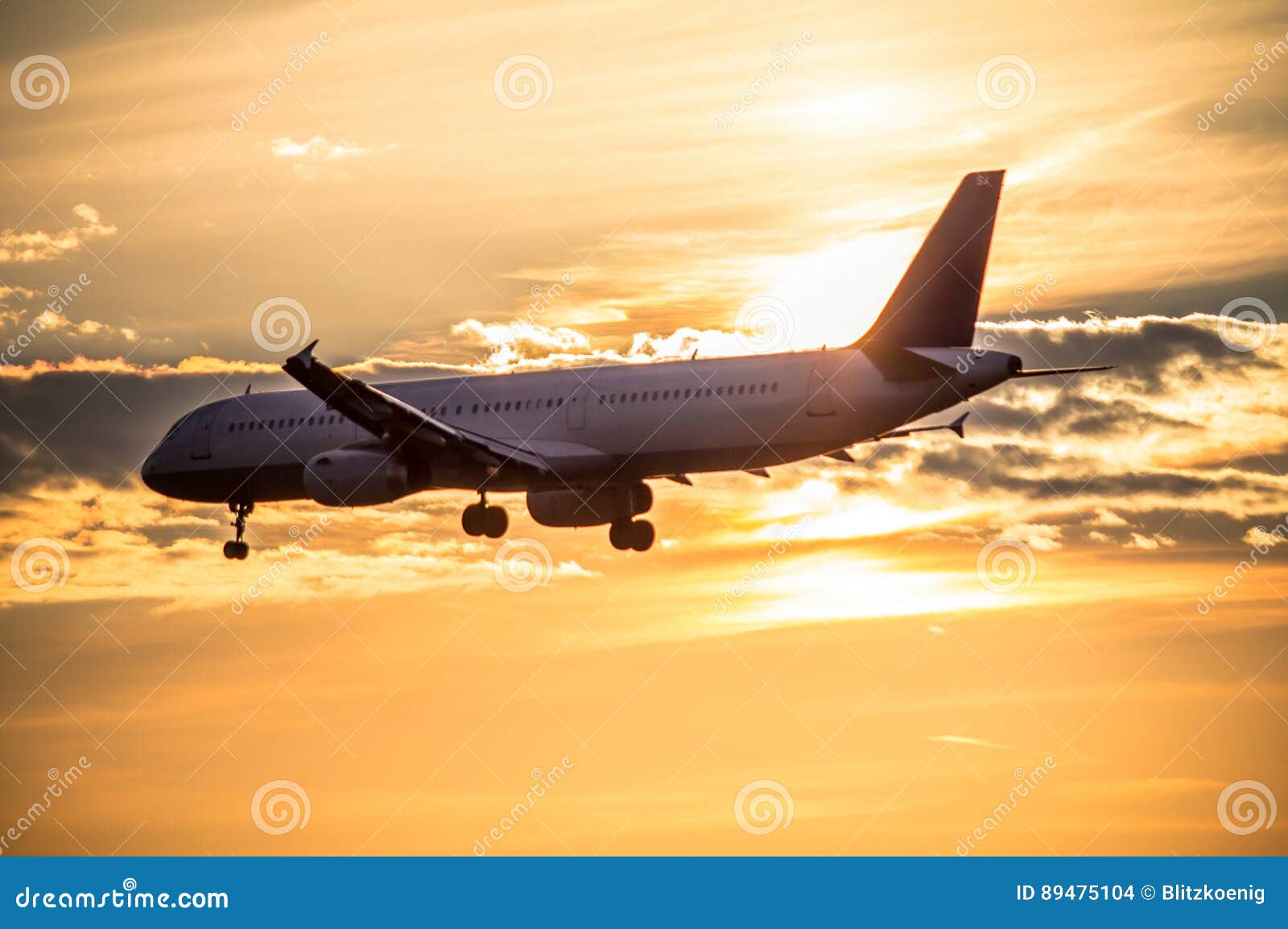 Airplane landing at sunset stock photo. Image of technology - 89475104