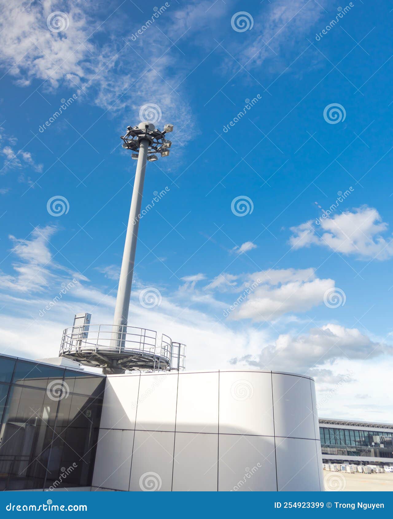 airport high mast lighting pole lights tower with antenna under cloud blue sky in tokyo, japan