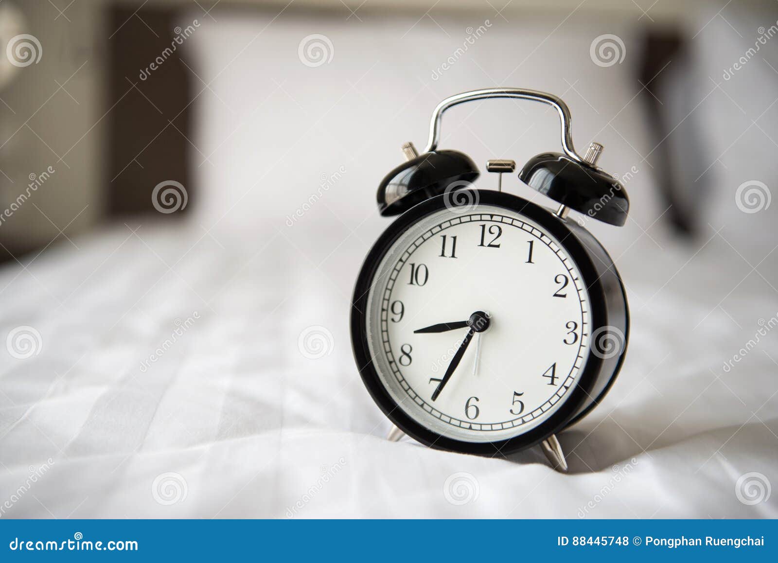 Alarm clock on bed stock photo. Image of indoors, bedroom 88445748