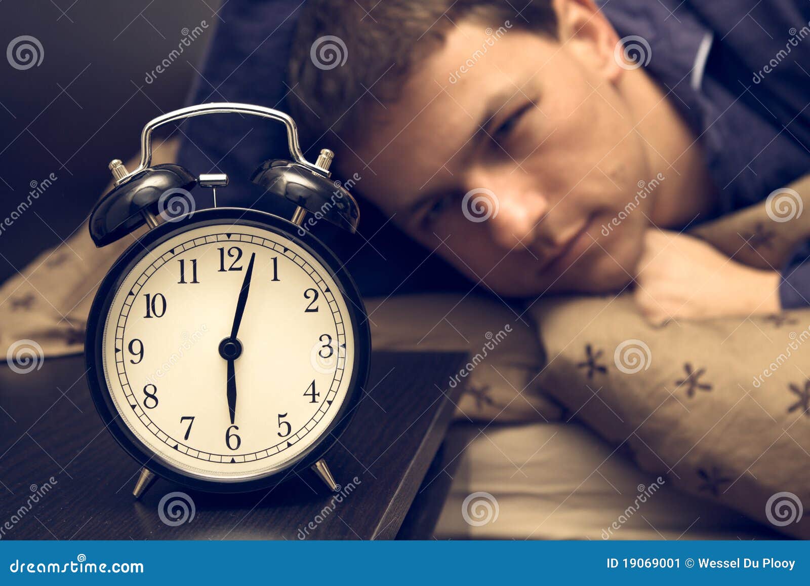 Alarm Clock with Male Model in Bed in Background. Stock Image Image