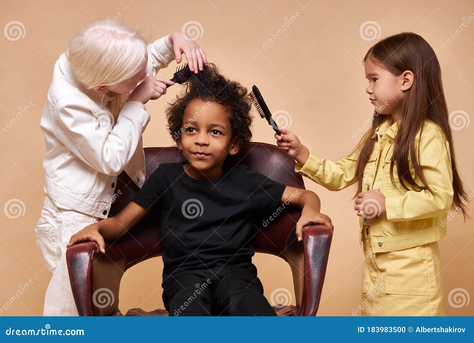 albino child girl combing curly hair of africanamerican boy 