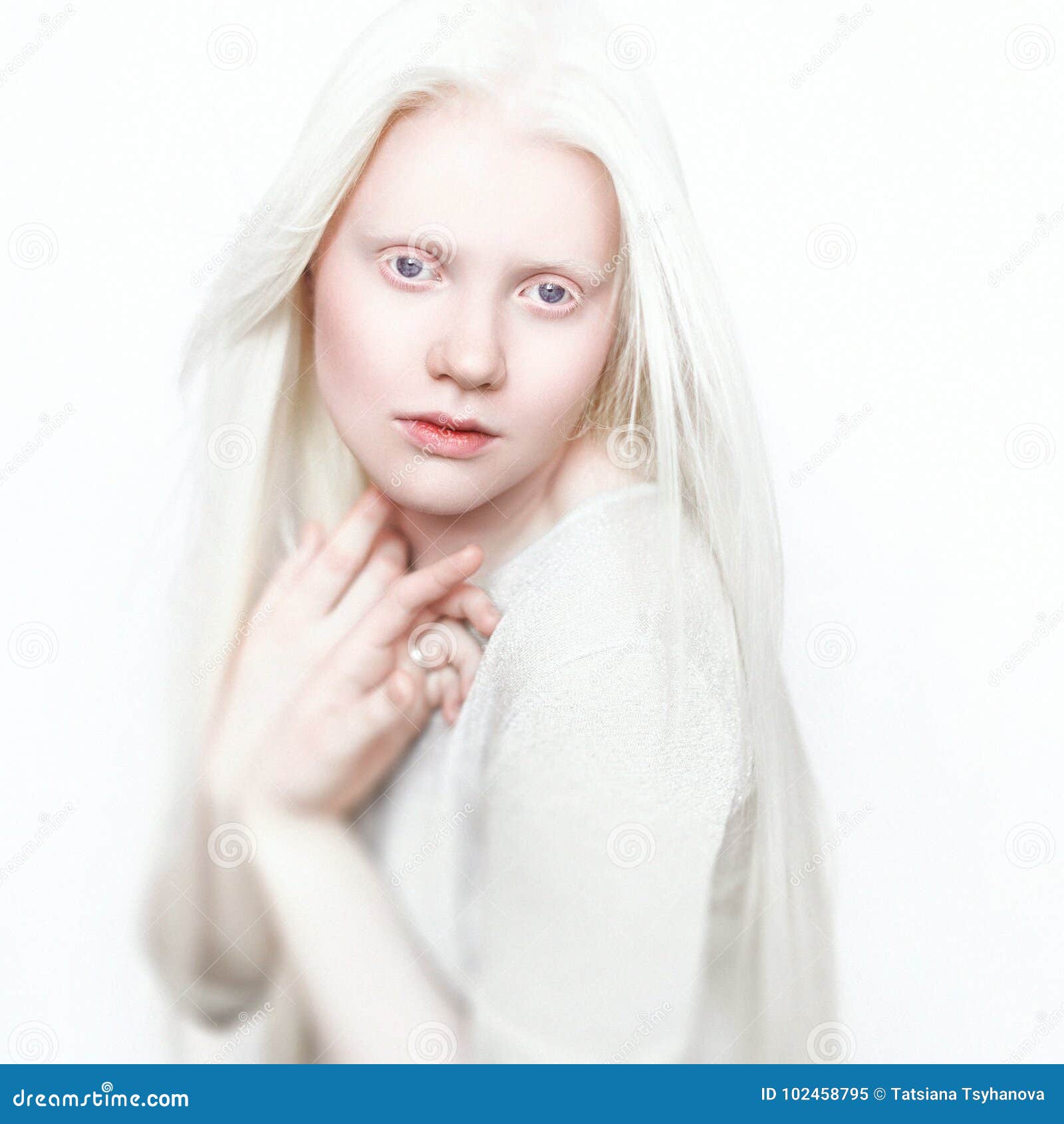 albino woman with white pure skin and white hair. photo face on a light background. portrait of the head. blonde girl