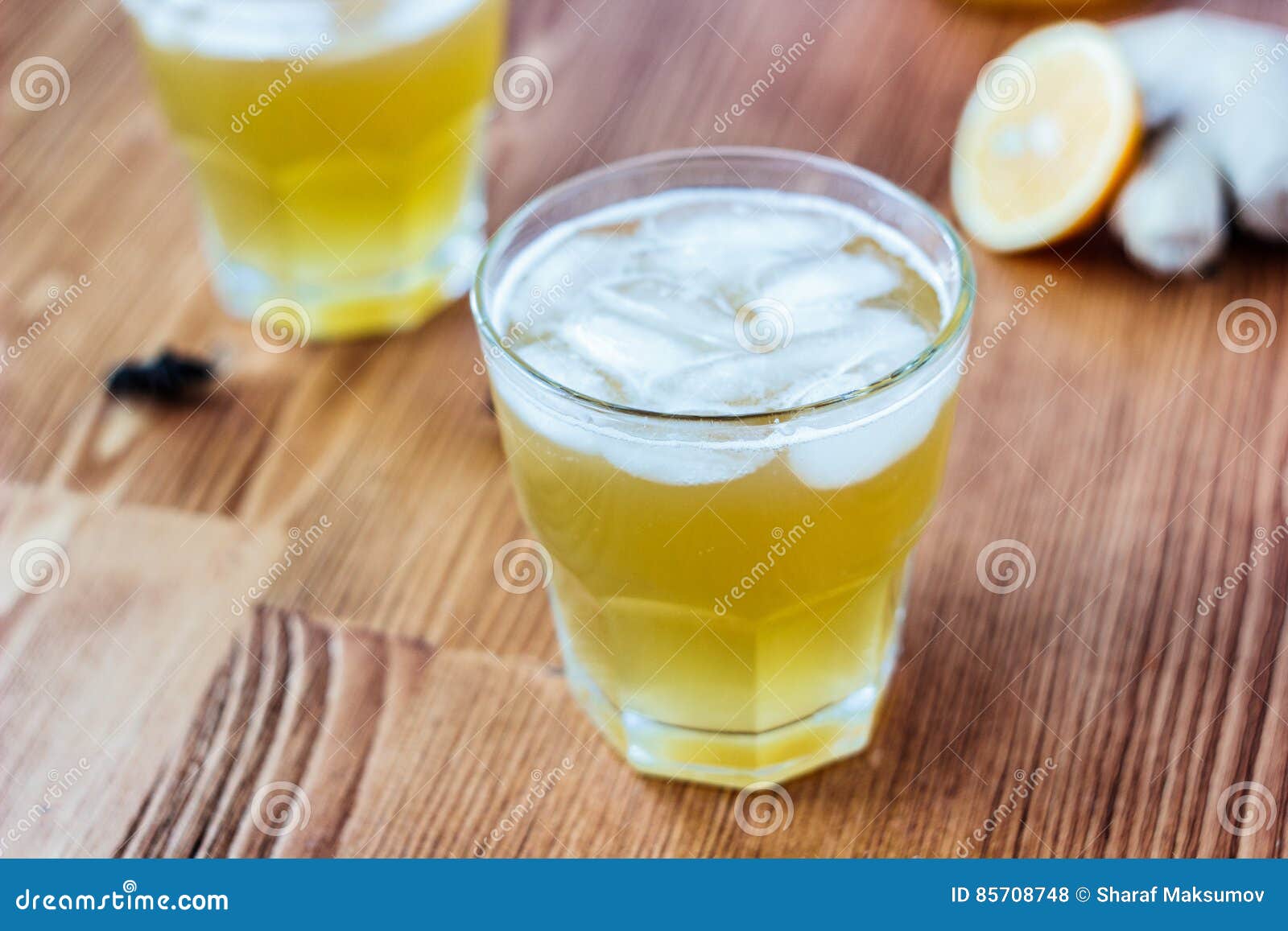 Alcohol free home ginger beer on glass on wooden surface.