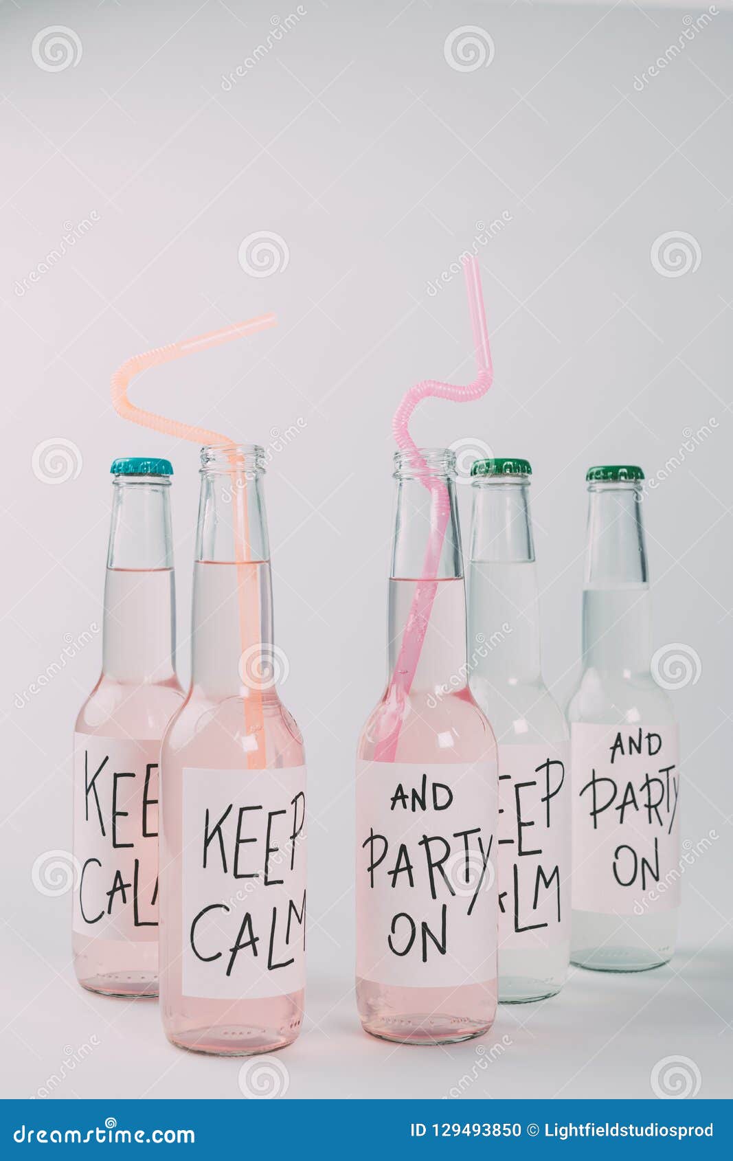 Closeup View of Alcoholic Beverages in Bottles with Drinking Straws