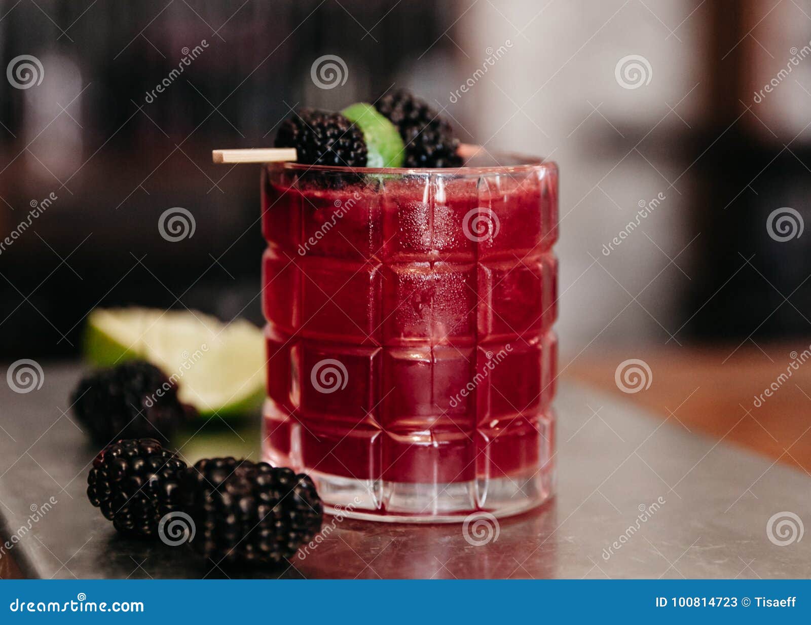 Summer Alcoholic Cocktail Garnished with Blackberries and Lime Stock