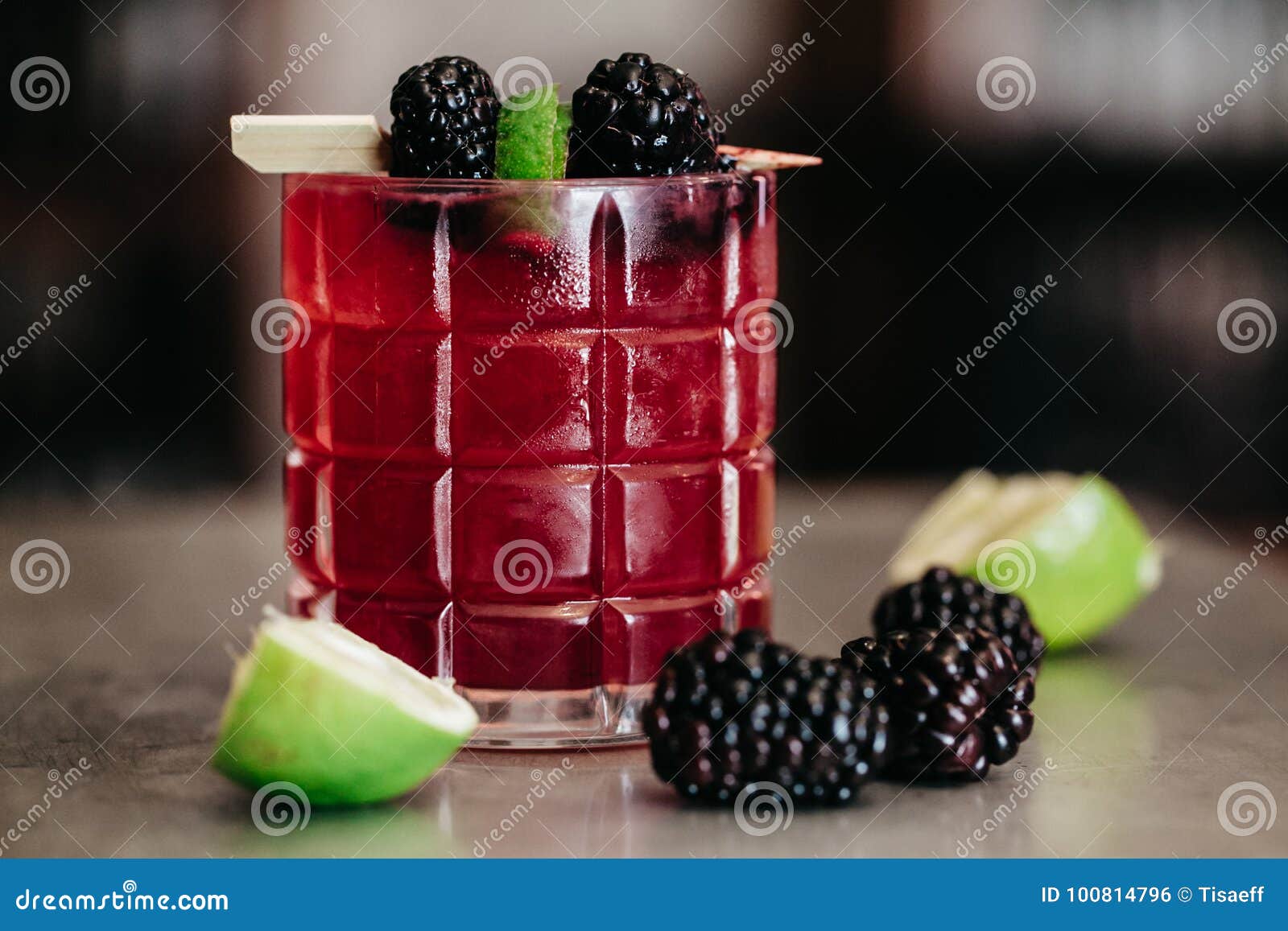 Summer Alcoholic Cocktail Garnished with Blackberries and Lime Stock