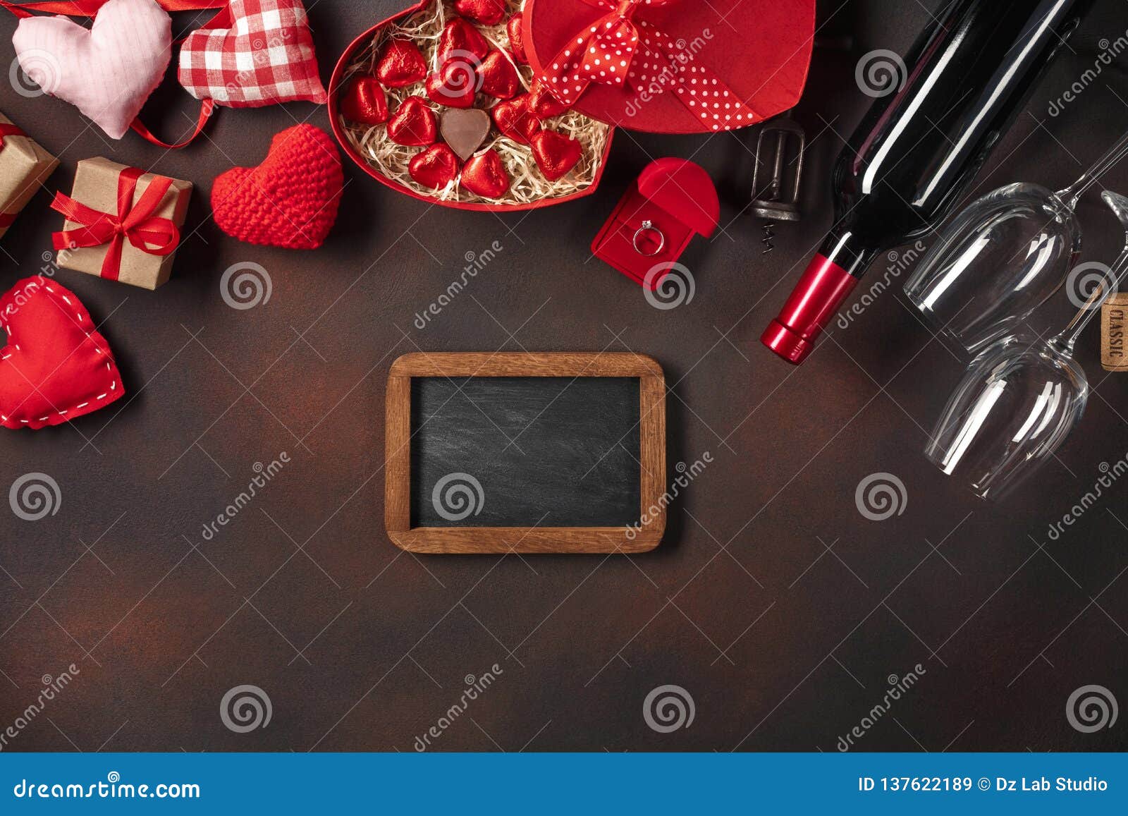 alentine`s day with hearts, wine, corkscrew, glasses, gifts, a heart-d box and a blackboard