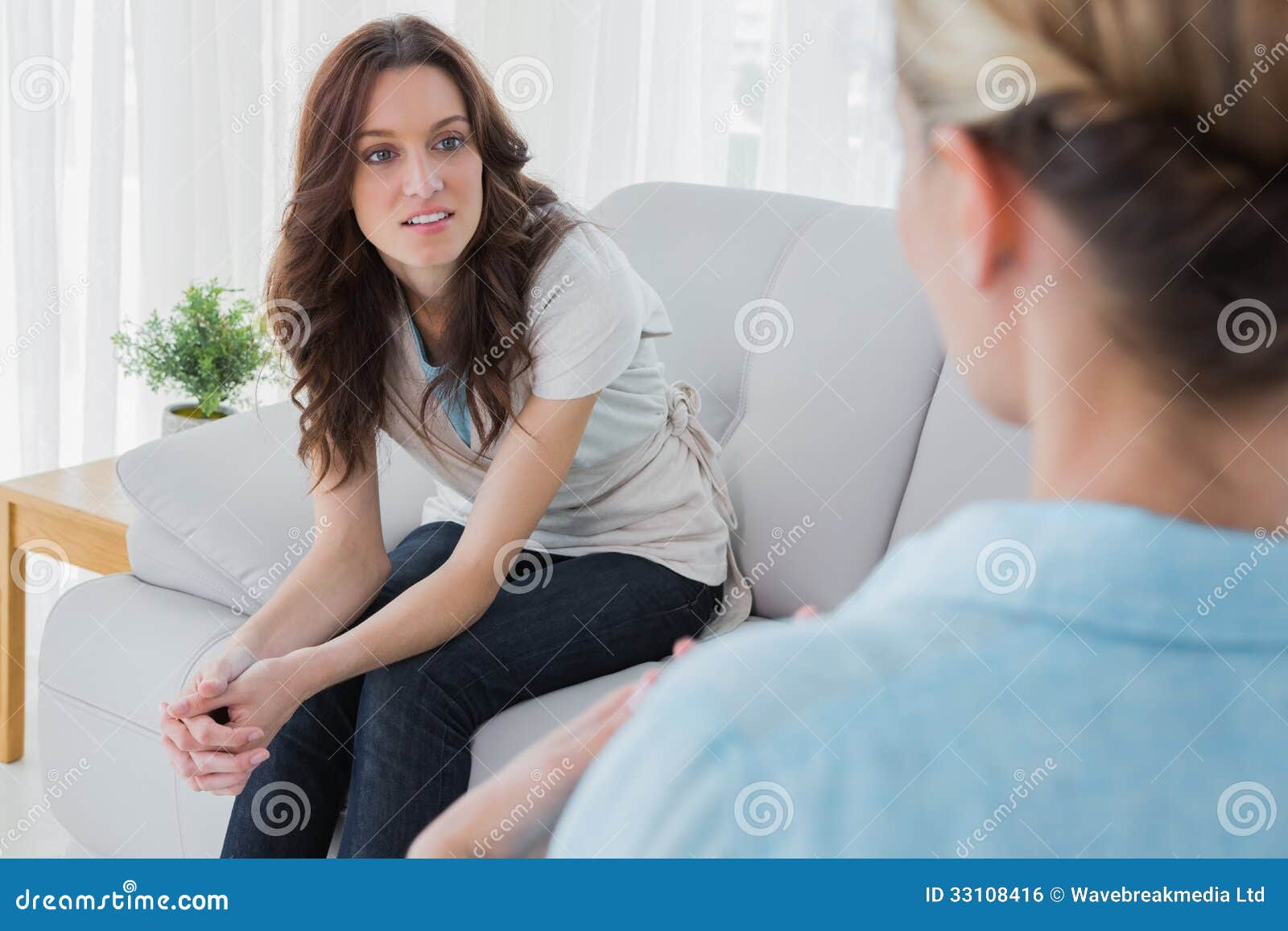 alert woman sitting with her therapist talking to her