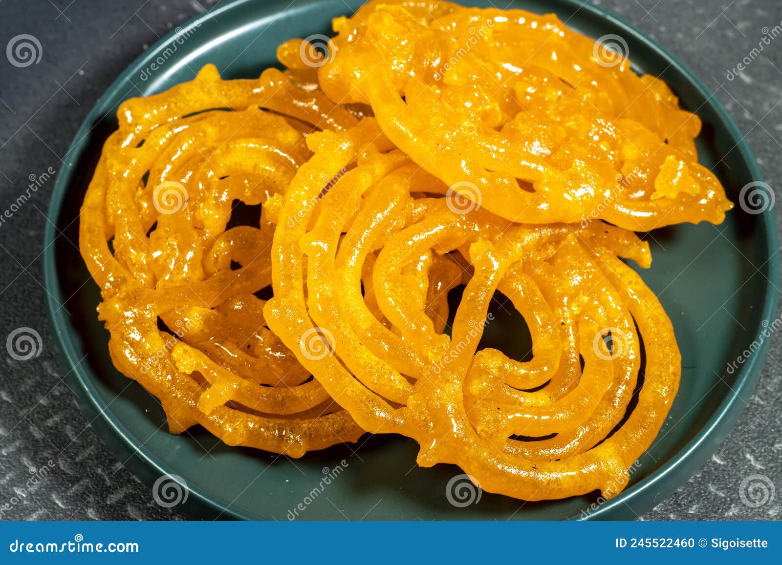 algeria sweet food named zlabi, in inde named jalebi, it is prepared with flour and yogurt and honey and other ingredients