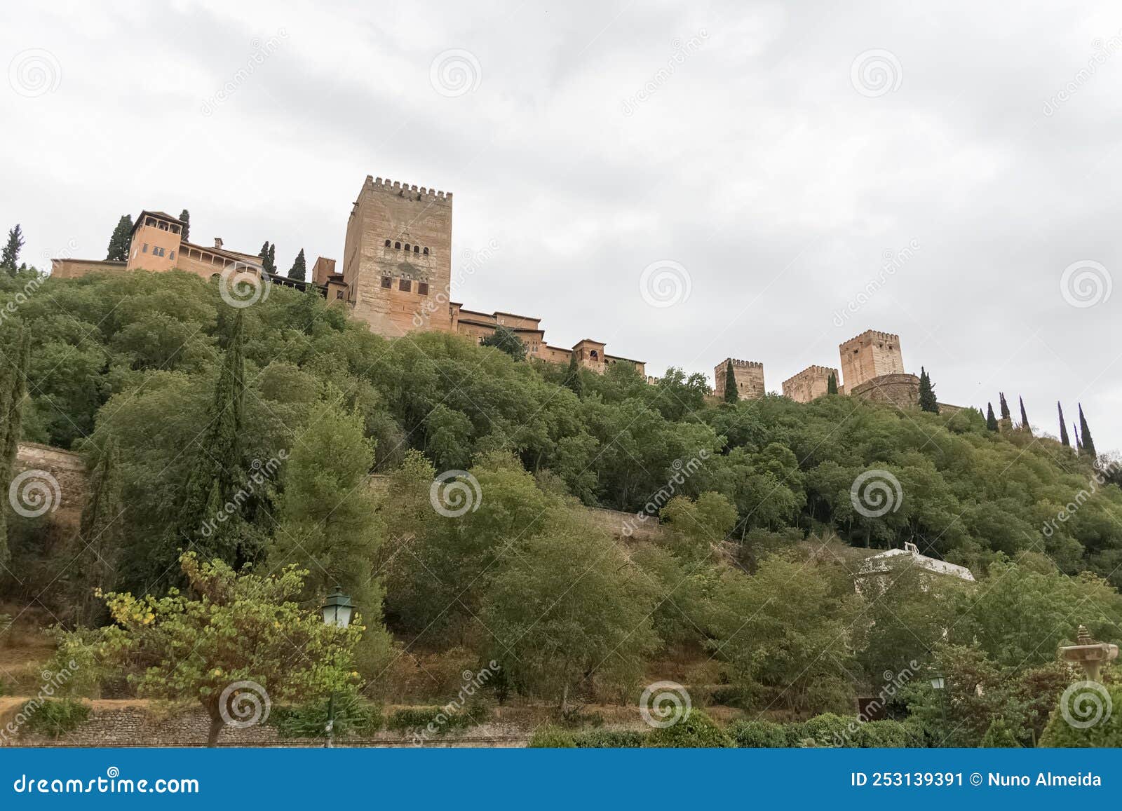 view at the alhambra citadel on top, from paseo de los tristes, walk of the sad (the promenade of the sad)