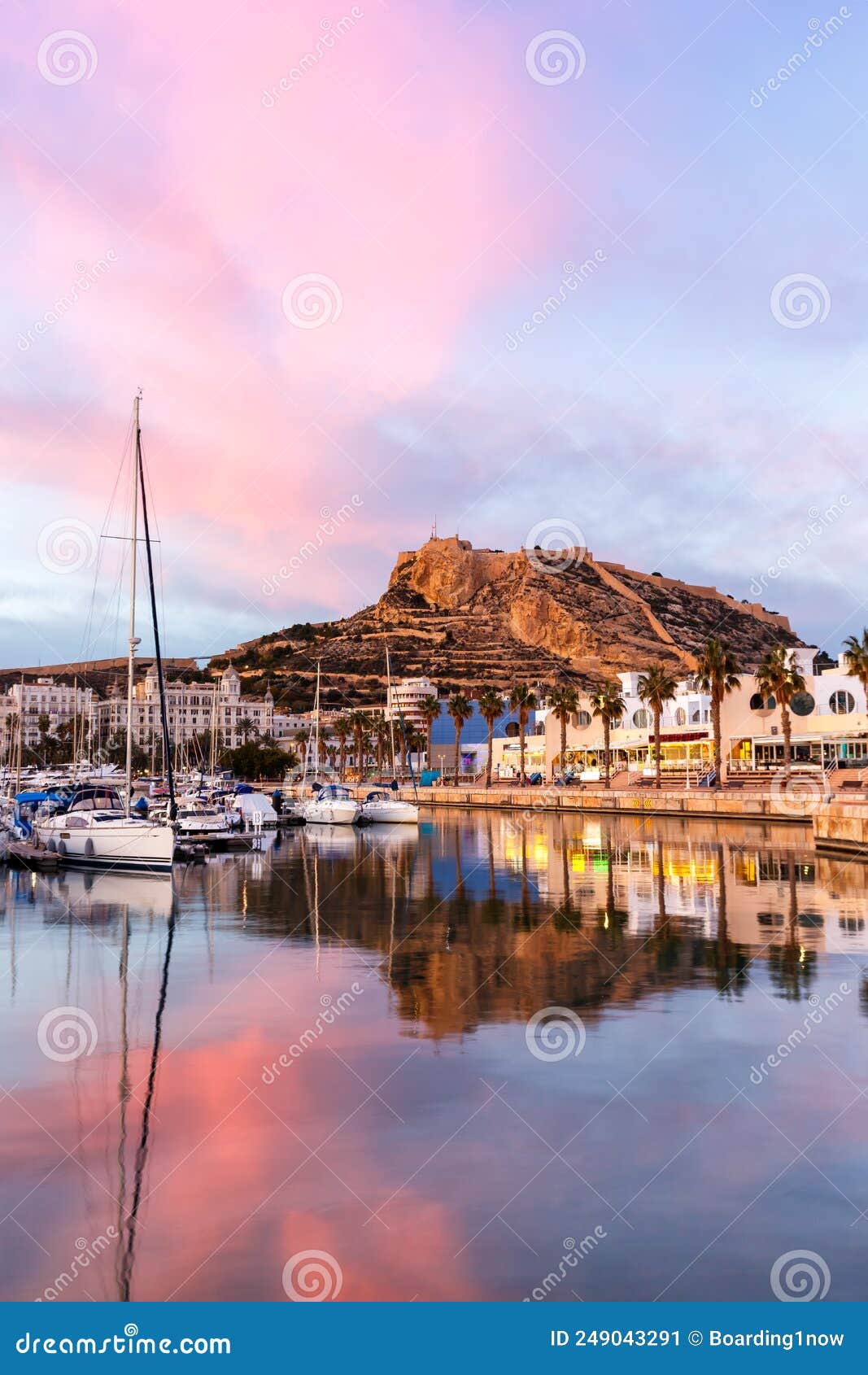 alicante port d`alacant marina with boats and view of castle castillo evening travel traveling holidays vacation portrait format
