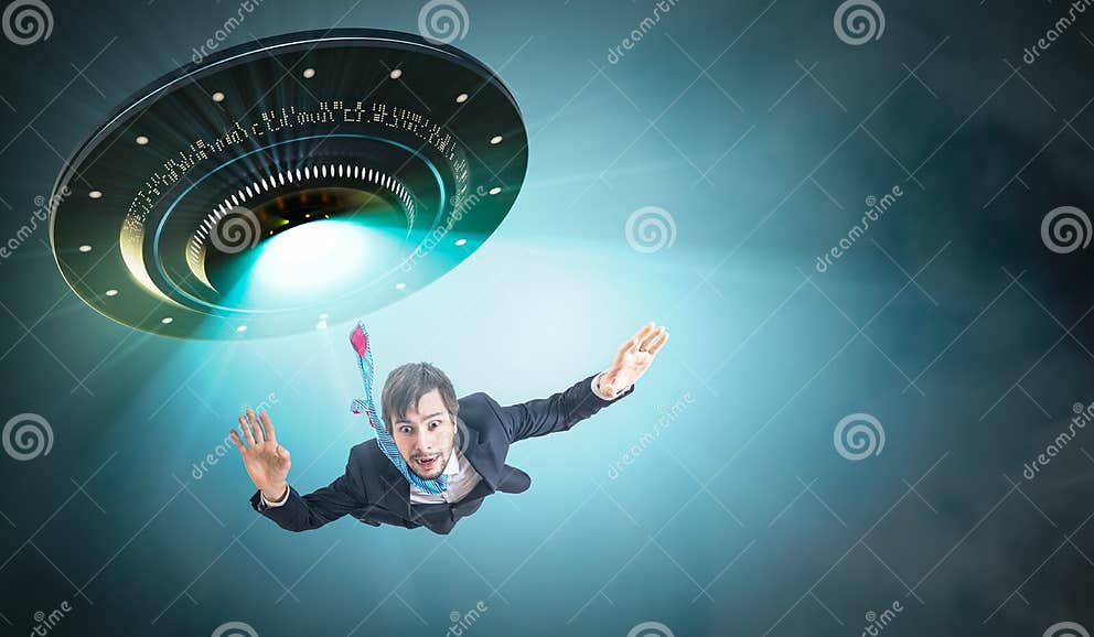 Alien Abduction Concept. Young Man is Abducted by UFO. Stock Image