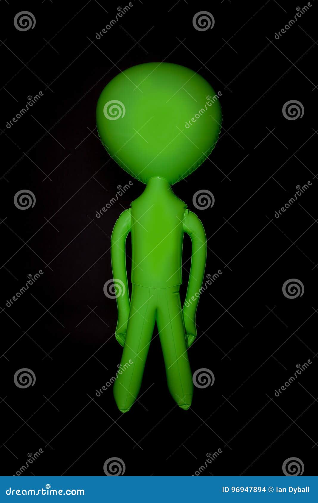 alien. blank inflatable little green man. stereotypical body   against black background.