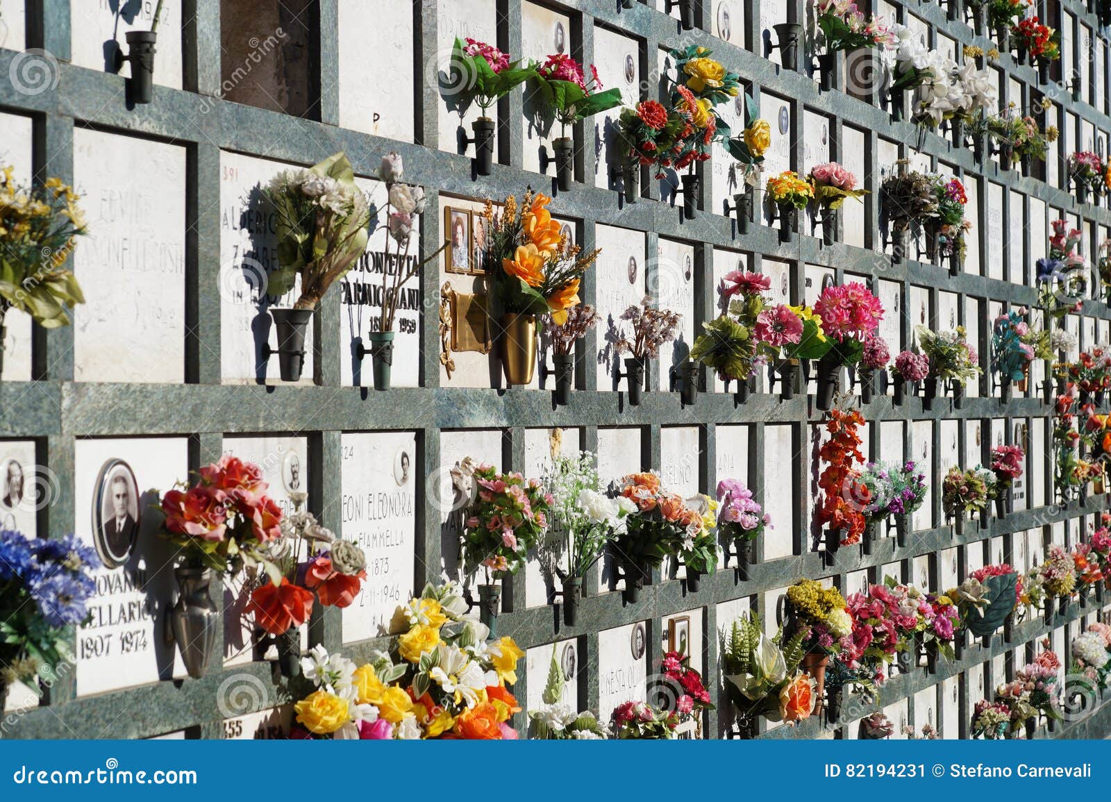 Aligned Tombstones in a Cemetery with Pink Tulips in Front of the ...