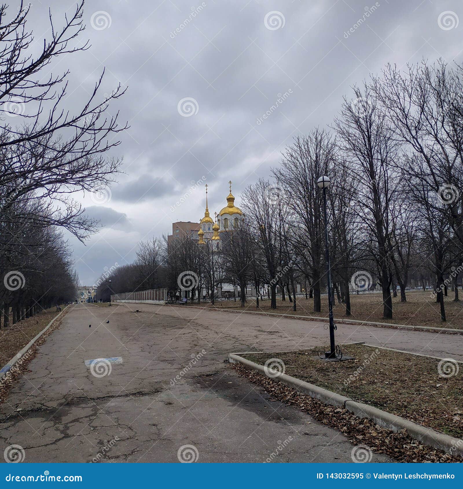 alley in the park leading to the holy trinity cathedral in kramatorsk