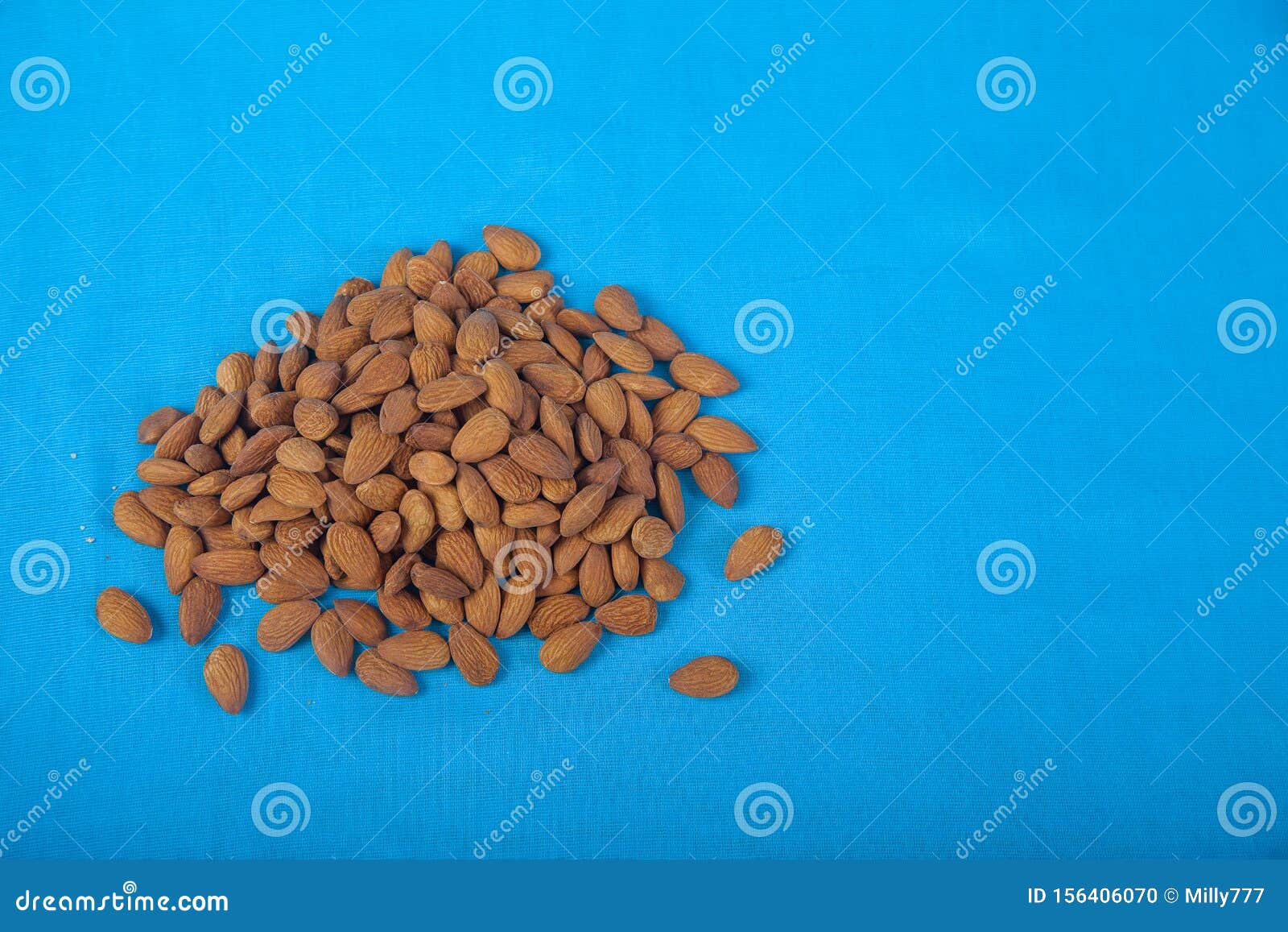 Almonds on a Blue Background. Flat Jay. Copy Spais. Horizontal Stock