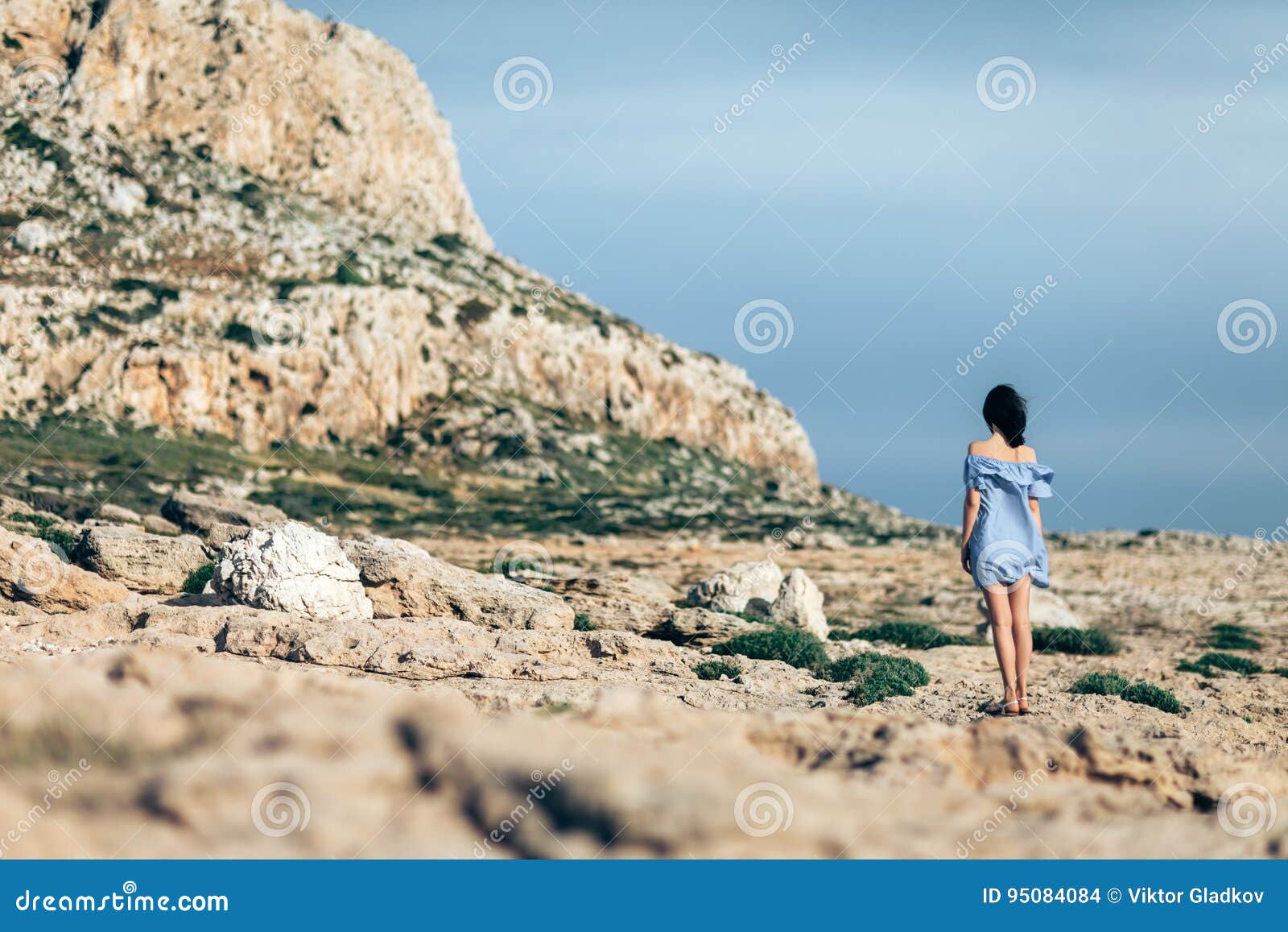 Alone Woman Walking on Rocky Desert with Dramatic Sky Stock Photo ...