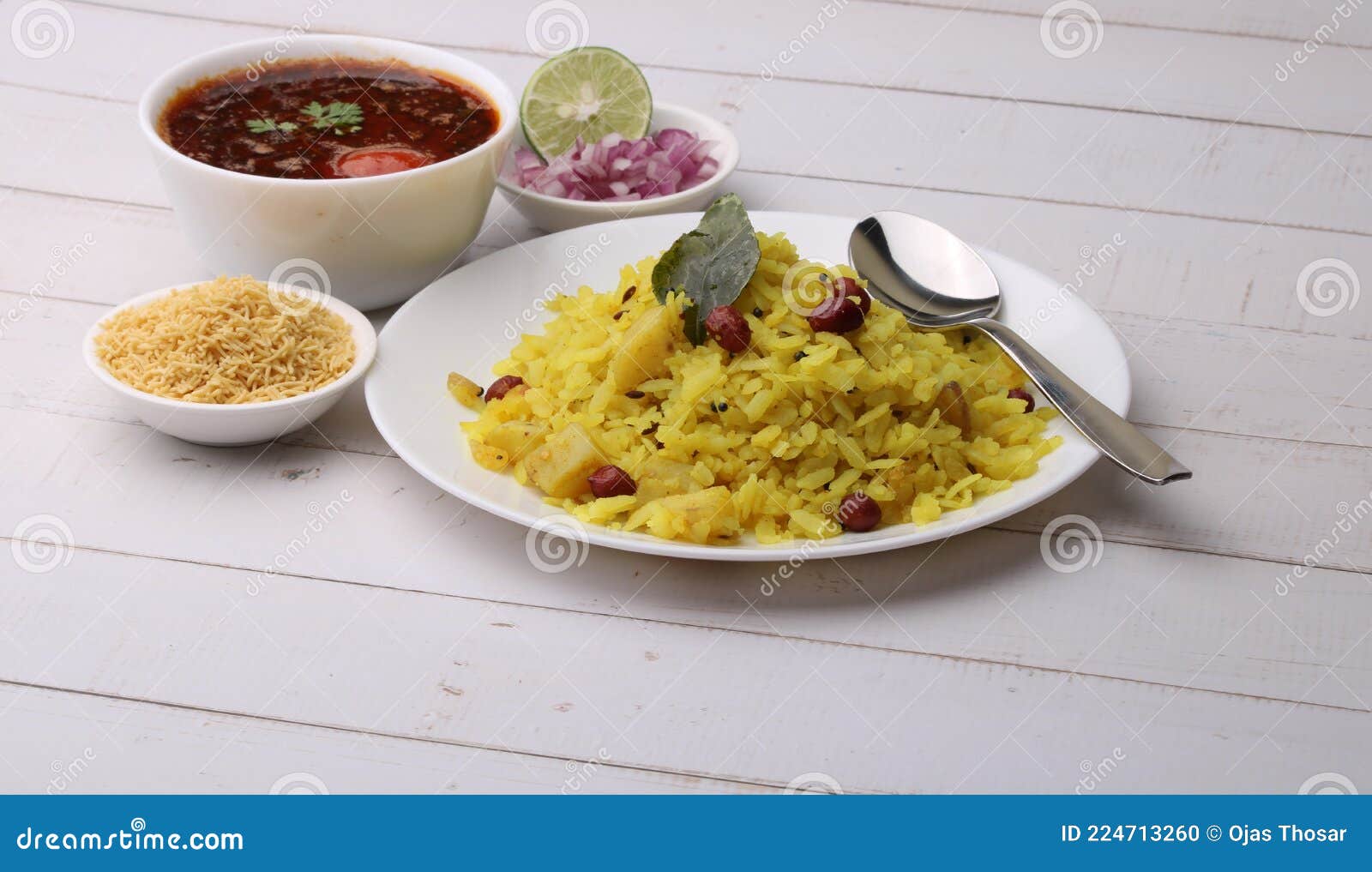 aloo/kanda poha or tarri pohe with spicy chana masala/curry. served in ceramic plate.