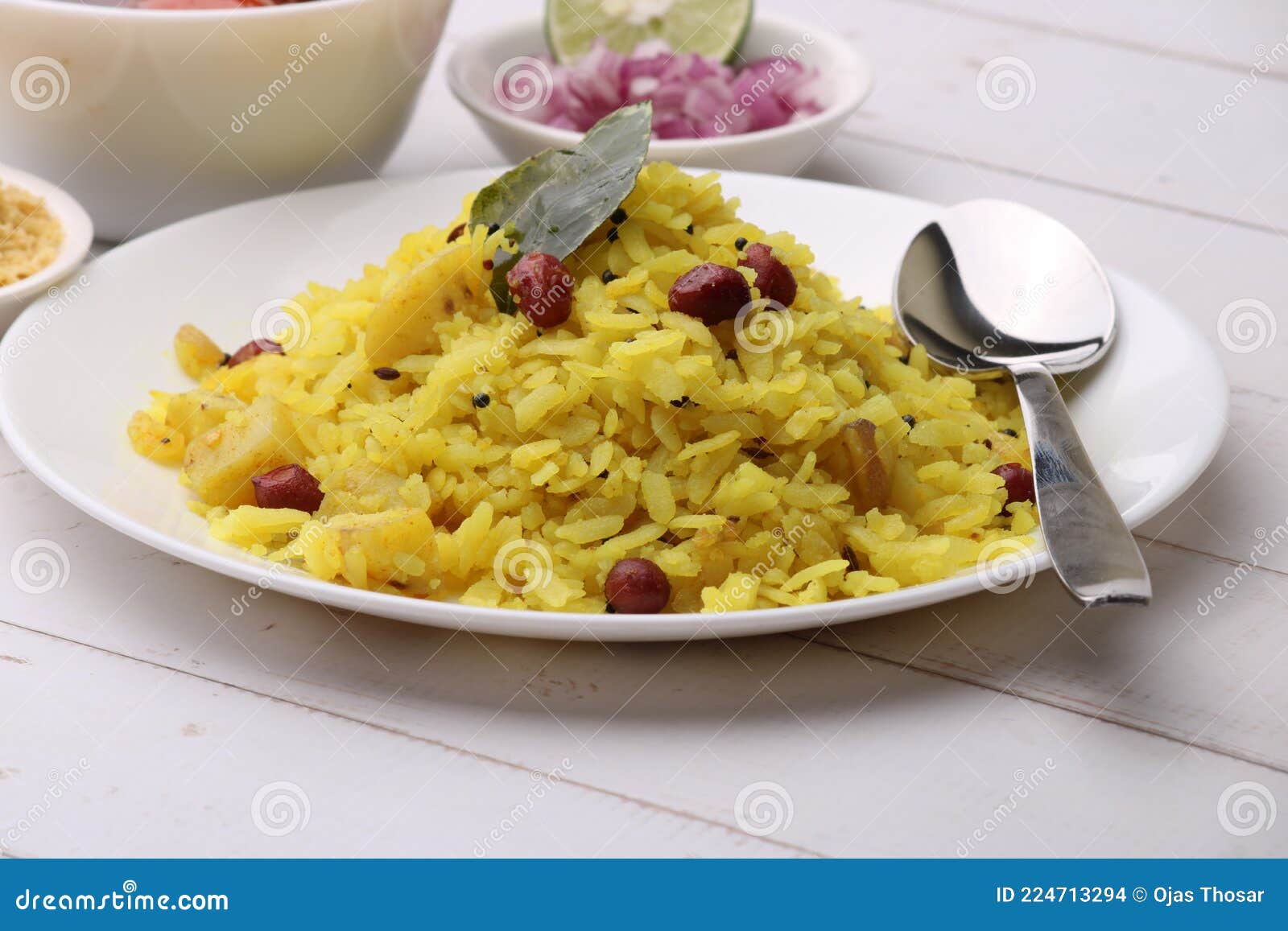 aloo/kanda poha or tarri pohe with spicy chana masala/curry. served in ceramic plate.