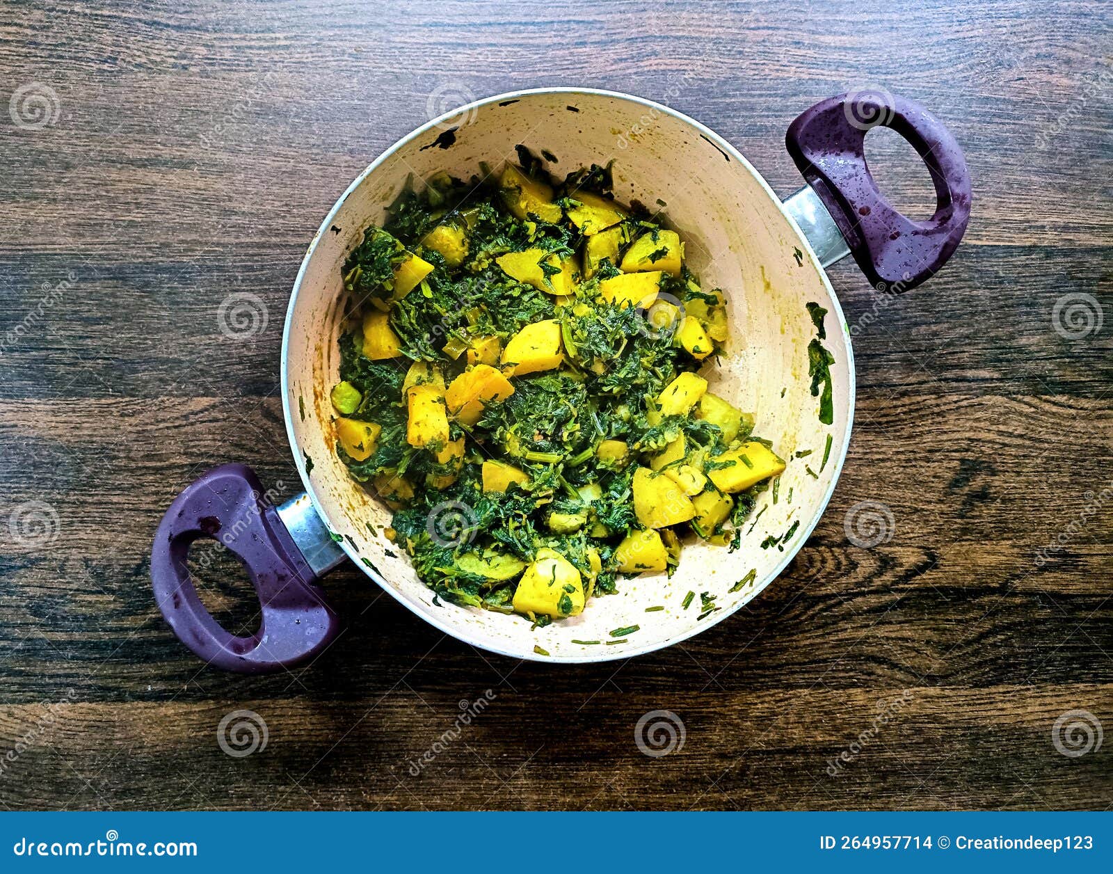 aloo palak sabzi - potato cooked with spinach with added spices. a healthy indian main course recipe