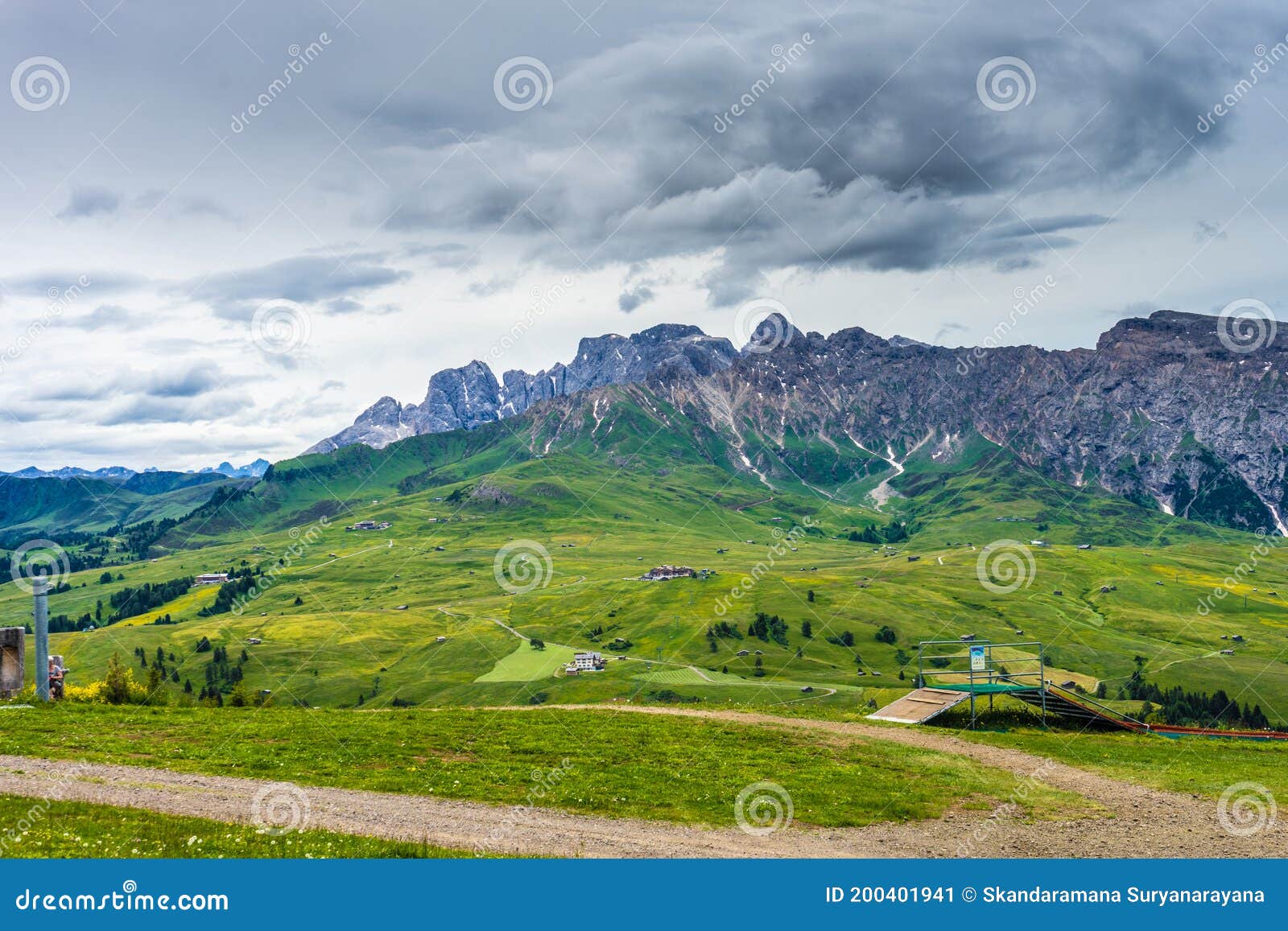 alpe di siusi, seiser alm with sassolungo langkofel dolomite, lush green field in seiser alm puflatsch bullaccia