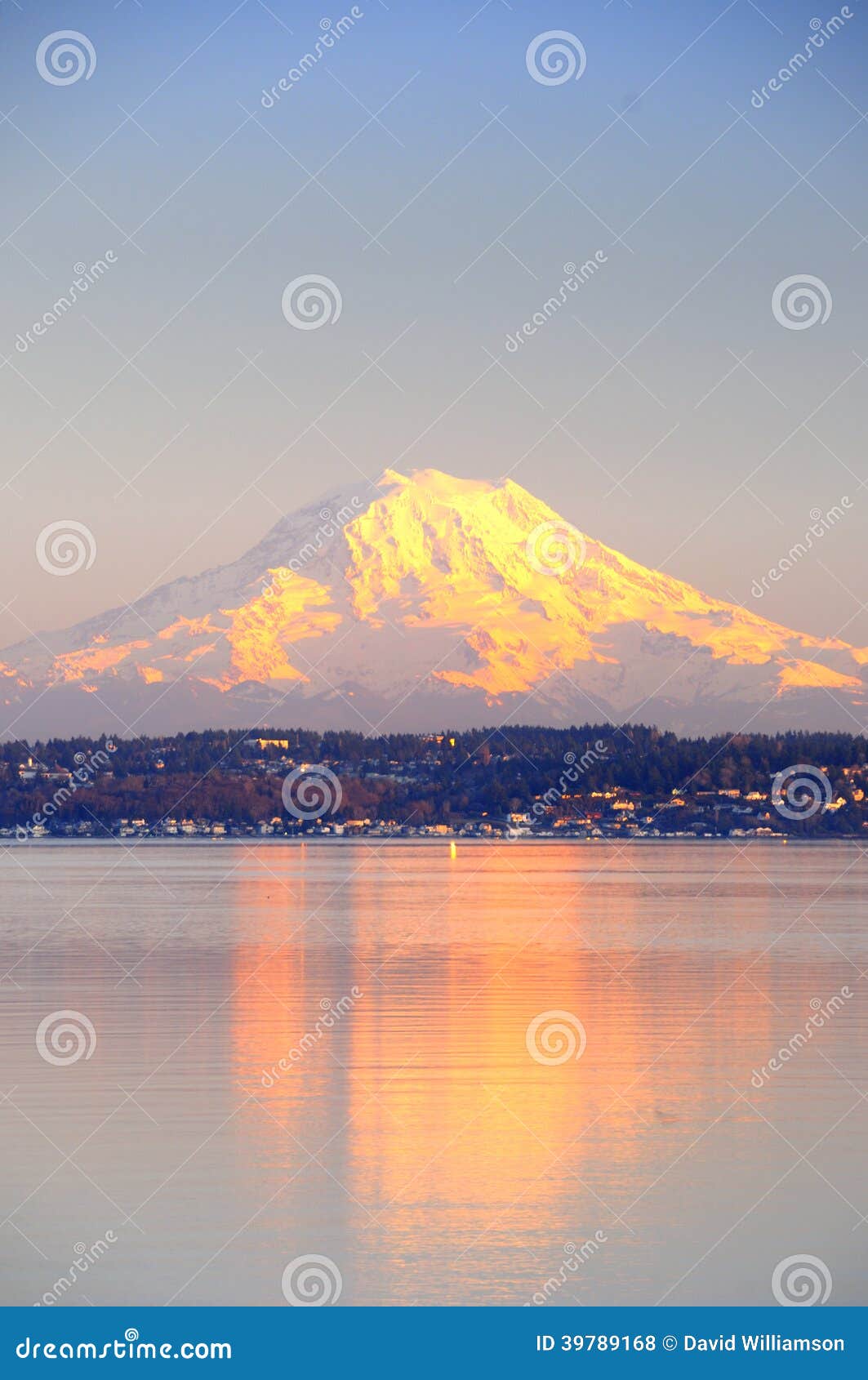 alpenglow on mount rainier reflects on puget sound