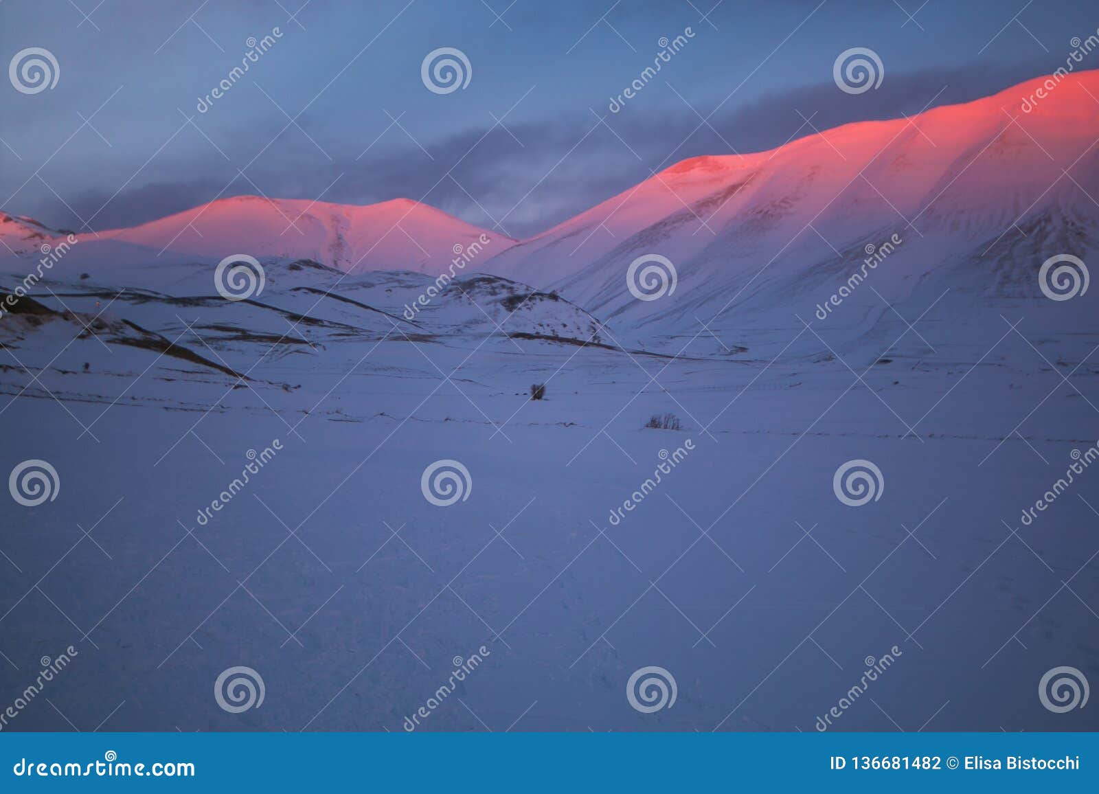 alpenglow phenomenon at the sunset on the peak of monte vettore in umbria, italy