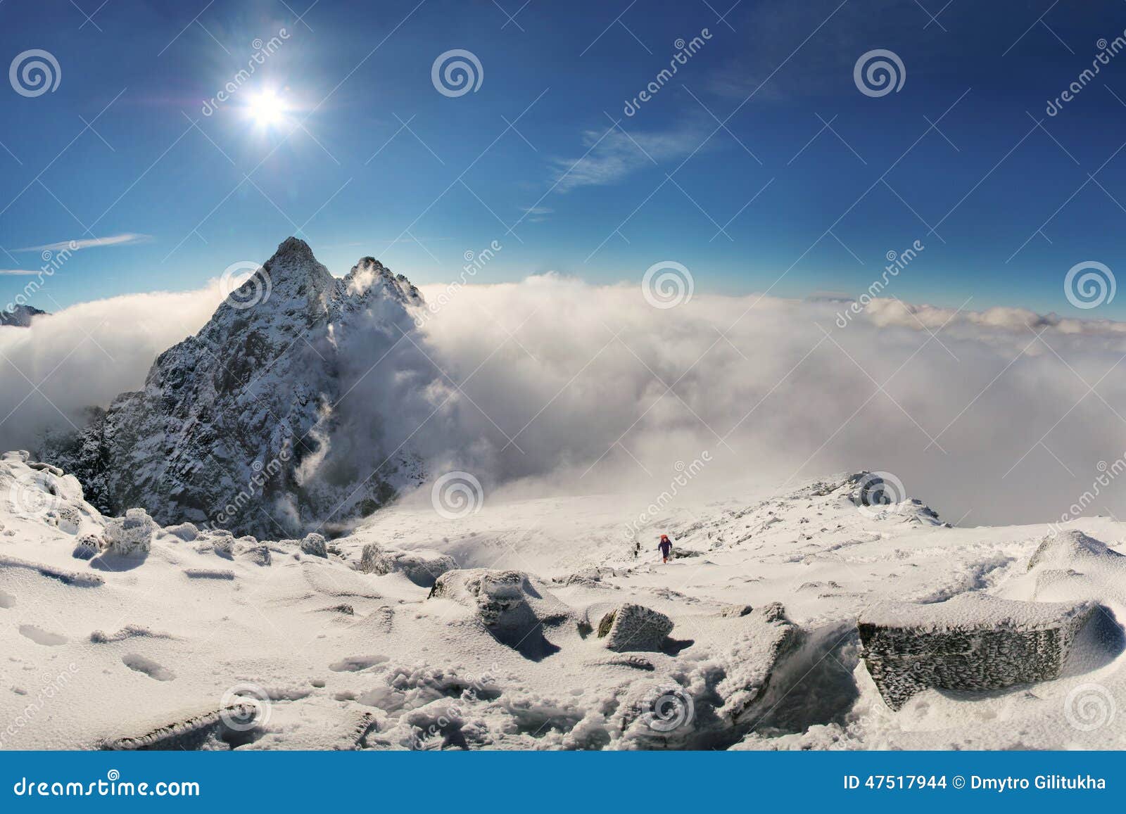 alpinist climbing on rysy mountain peak in high tatras. slovakia