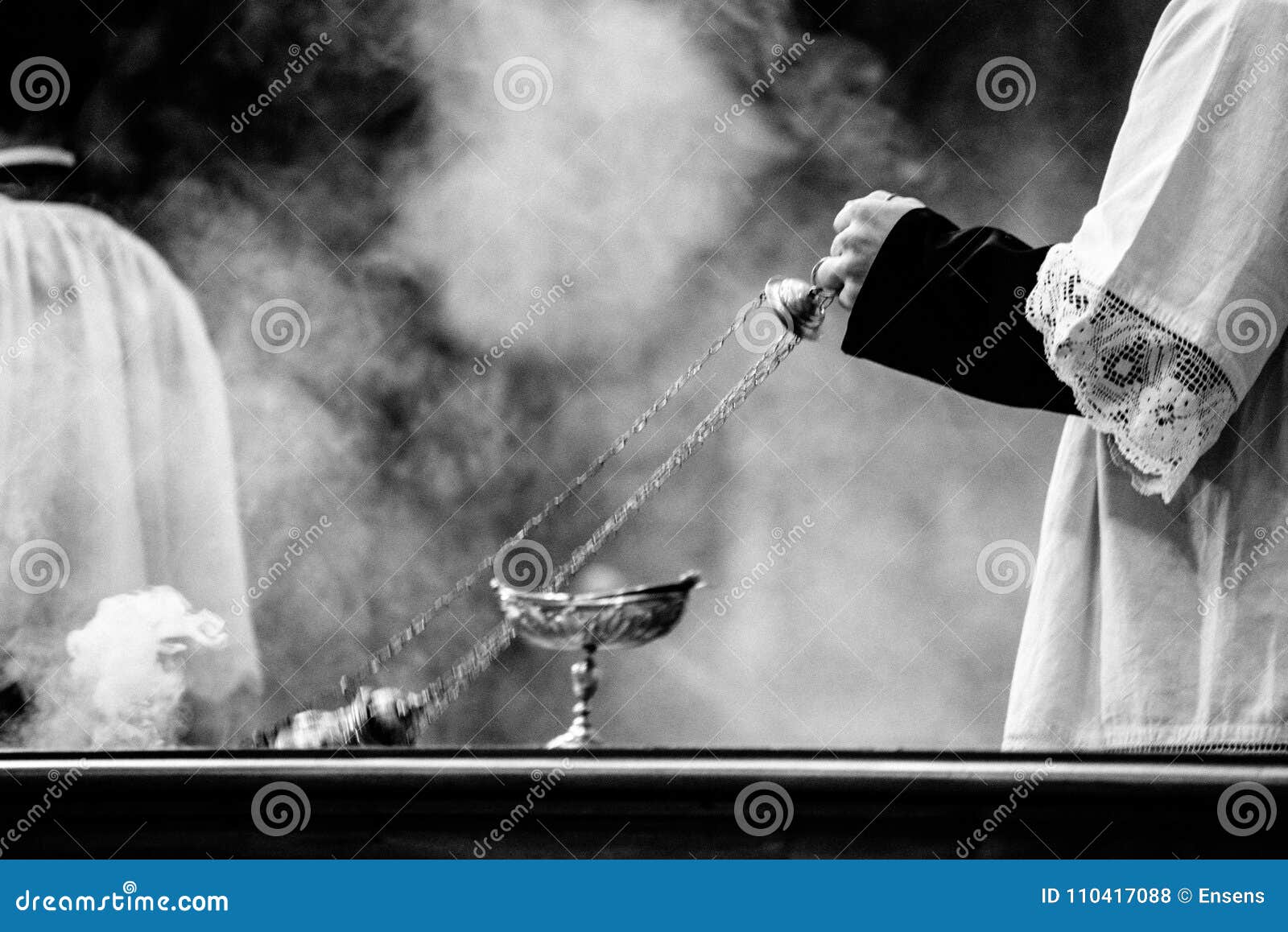 altar boy of the catholic church with thurible in his hand during a celebration