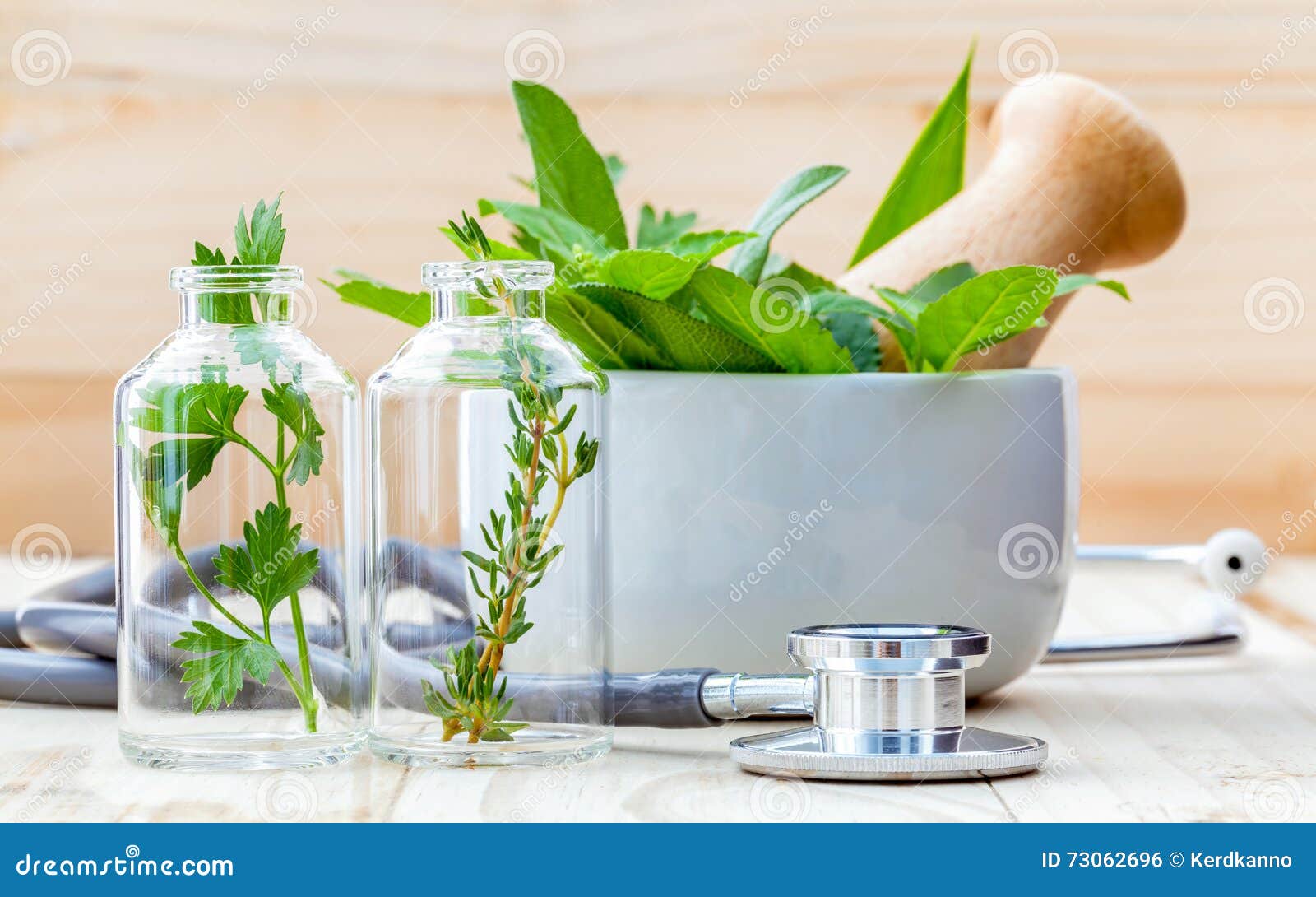 alternative health care concept. fresh herbs green mint ,rosemary ,parsley ,sage and lemon thyme in laboratory glassware with ste