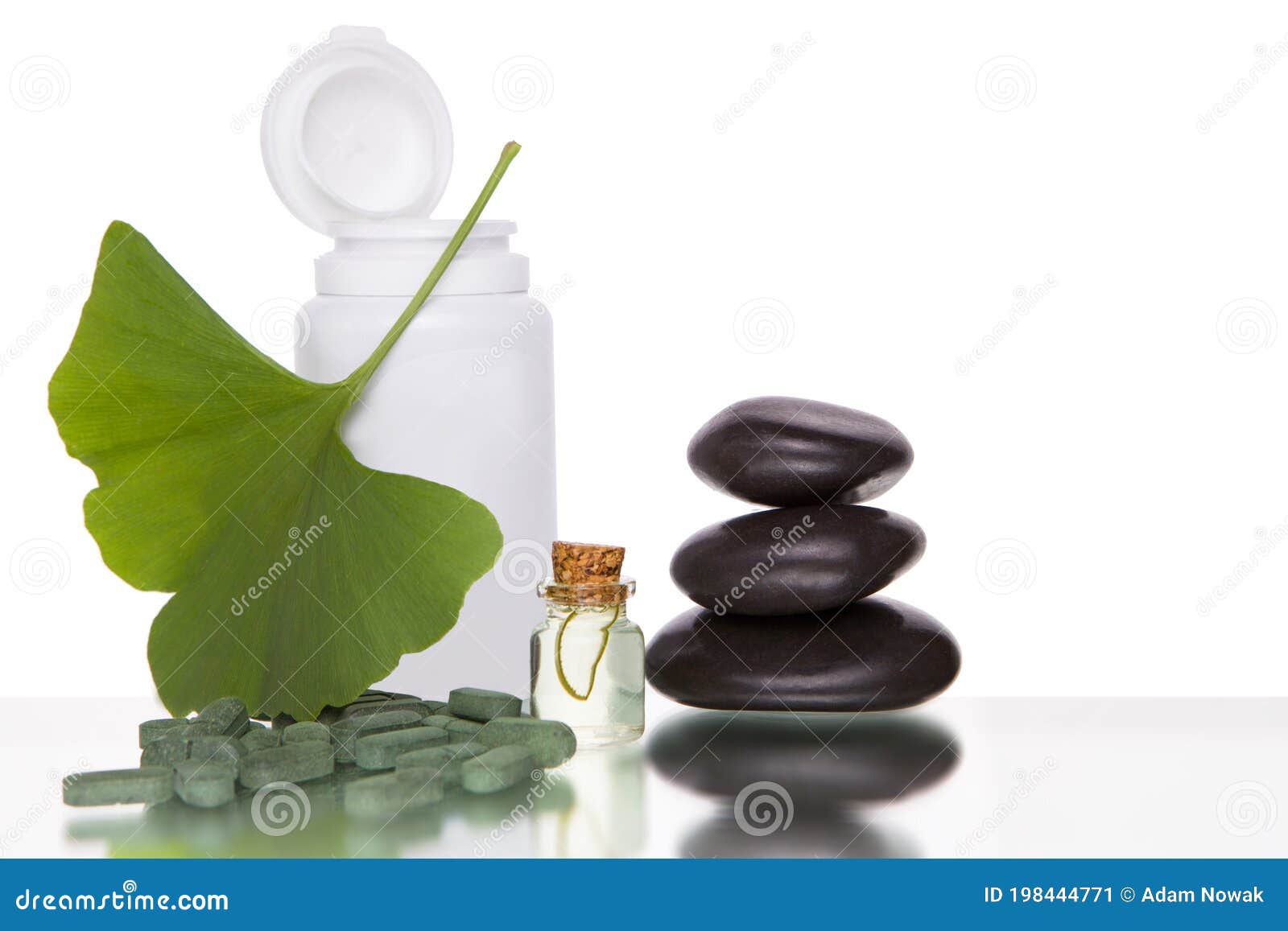 alternative medicine - ginkgo leaves and tablets n a bottle.  over white background