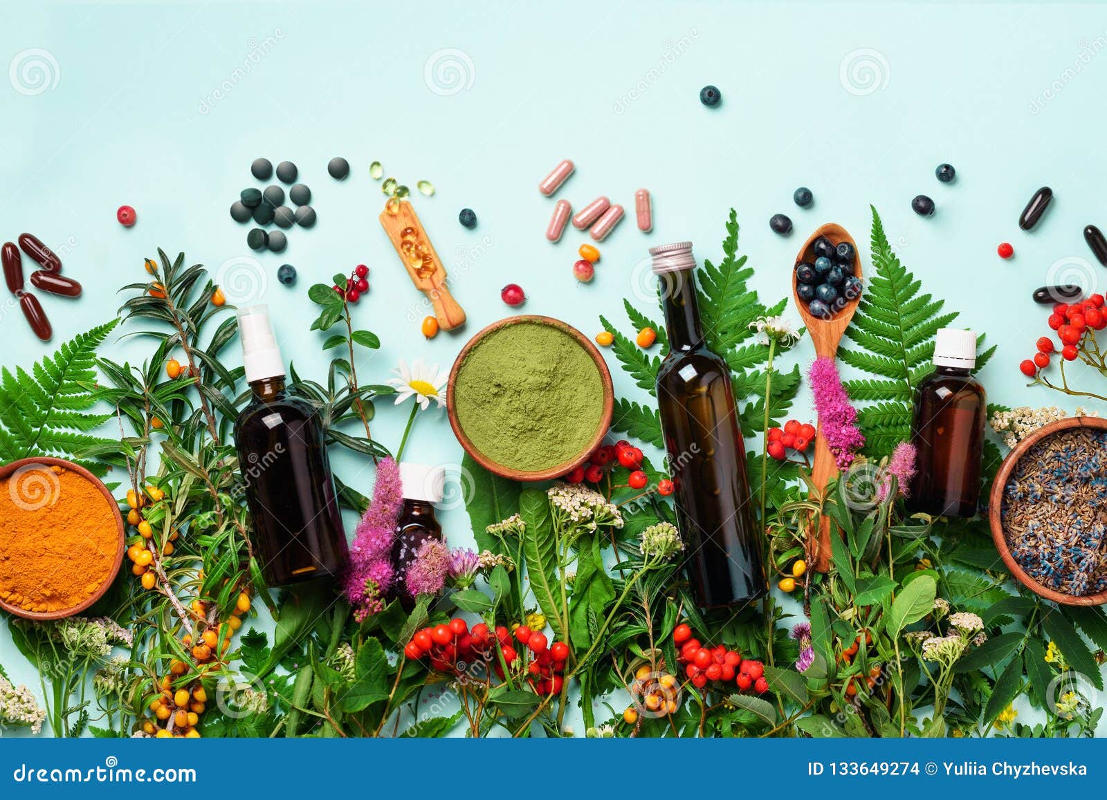 alternative medicine. holistic approach. healing herbs and flowers over blue background. top view, copy space, flat lay. banner