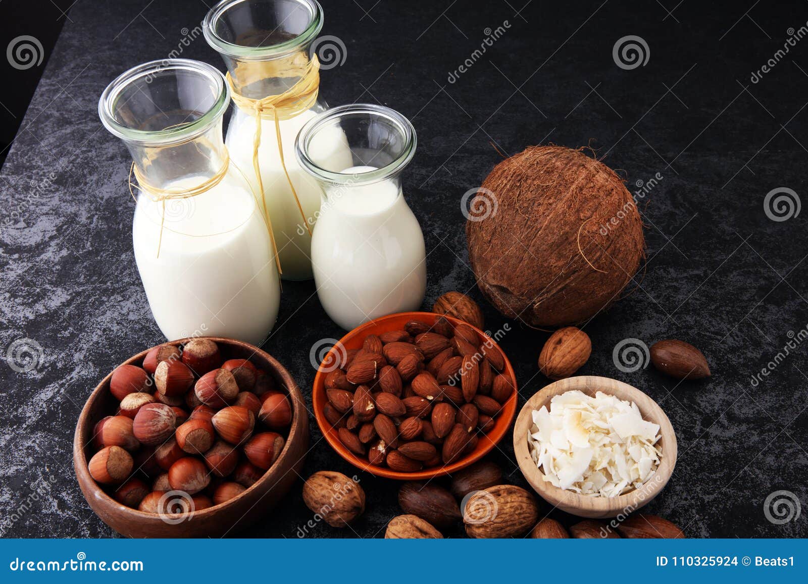Alternative Types Of Vegan Milks In Bottles On A Yellow Background