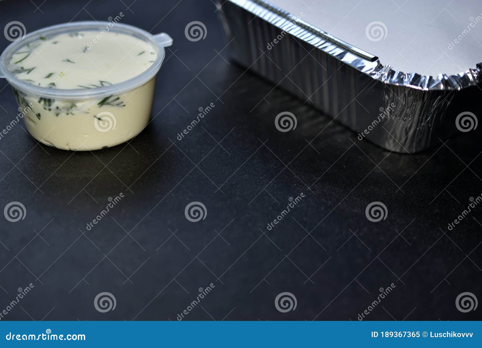Aluminum Container with Food and White Sauce with a Jar Stock Image