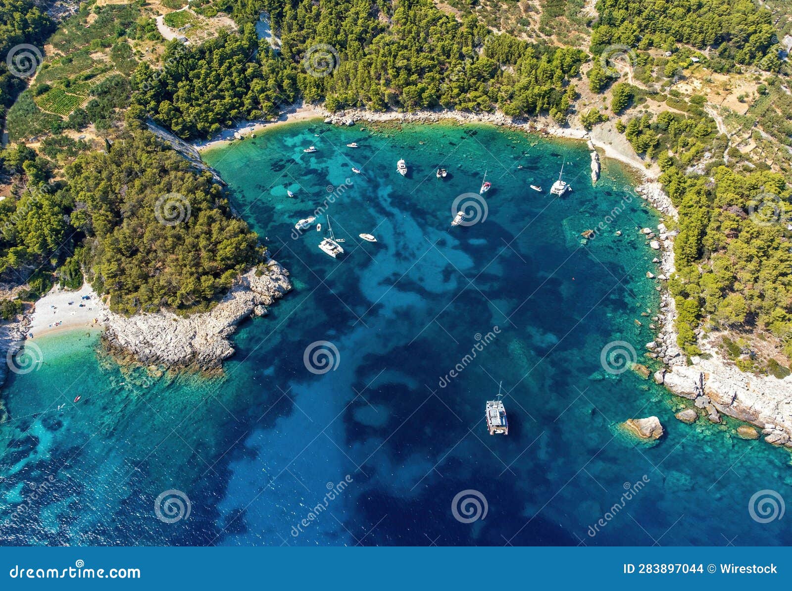 aerial photo of boats moored at beautiful velo borce beach on hvar island in croatia