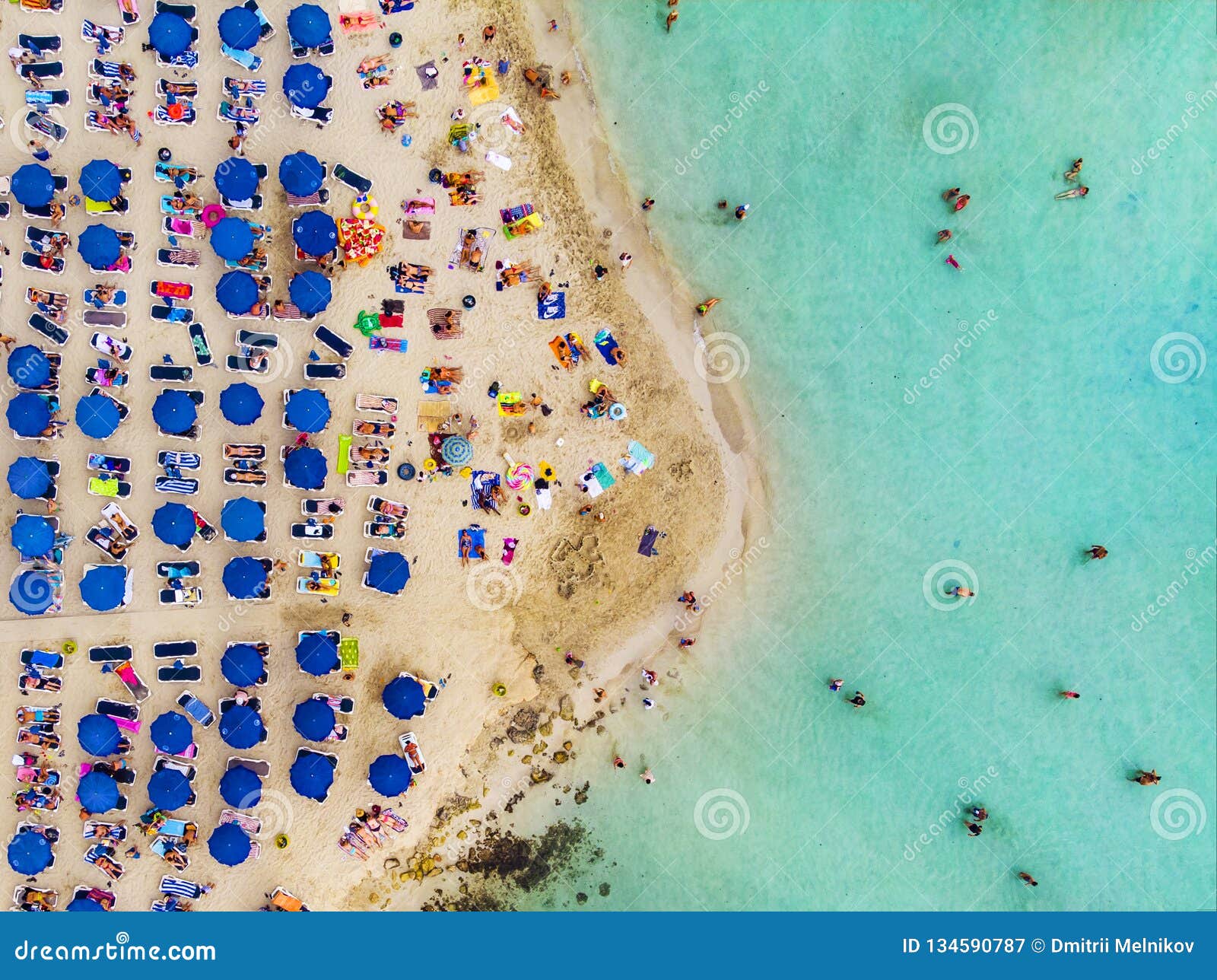 amazing aerial view from above over nissi beach in cyprus. nissi beach at high tide. tourists relax on the beach. crowded beach